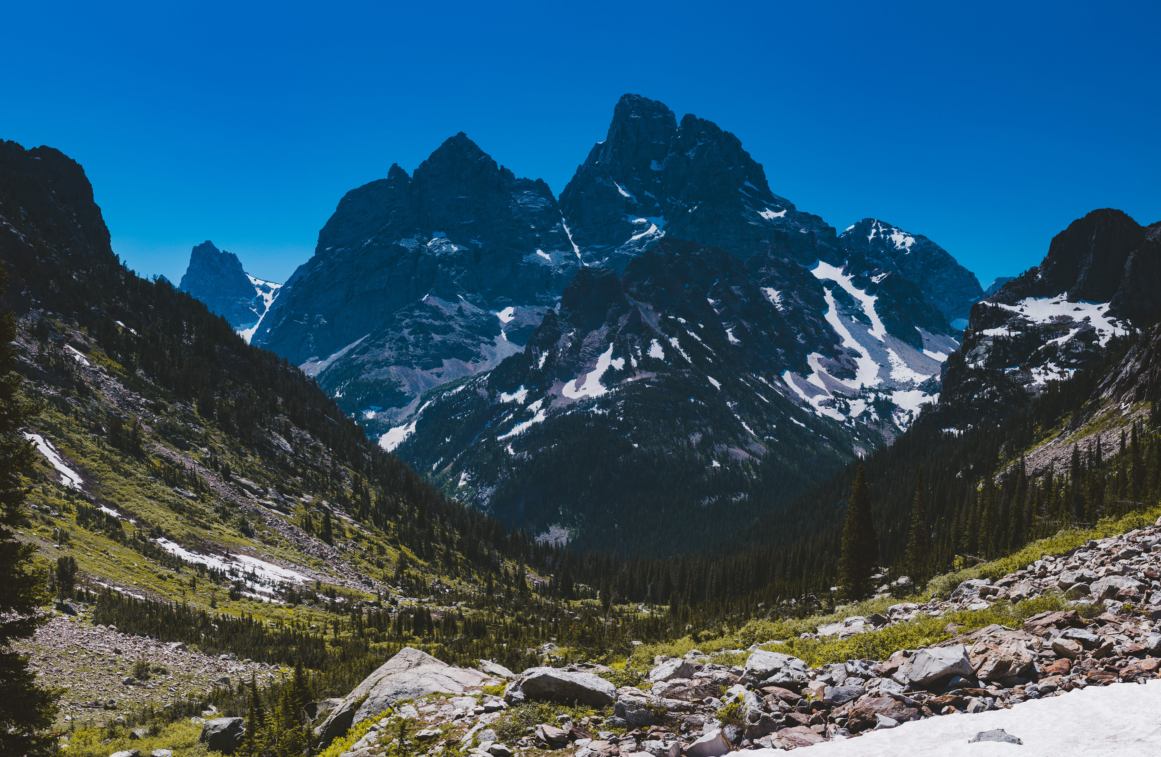 Photograph looking back at Mount Owen on the way to Lake Solitude in Grand Teton National Park, Wyoming, with rugged alpine terrain and steep granite peaks.