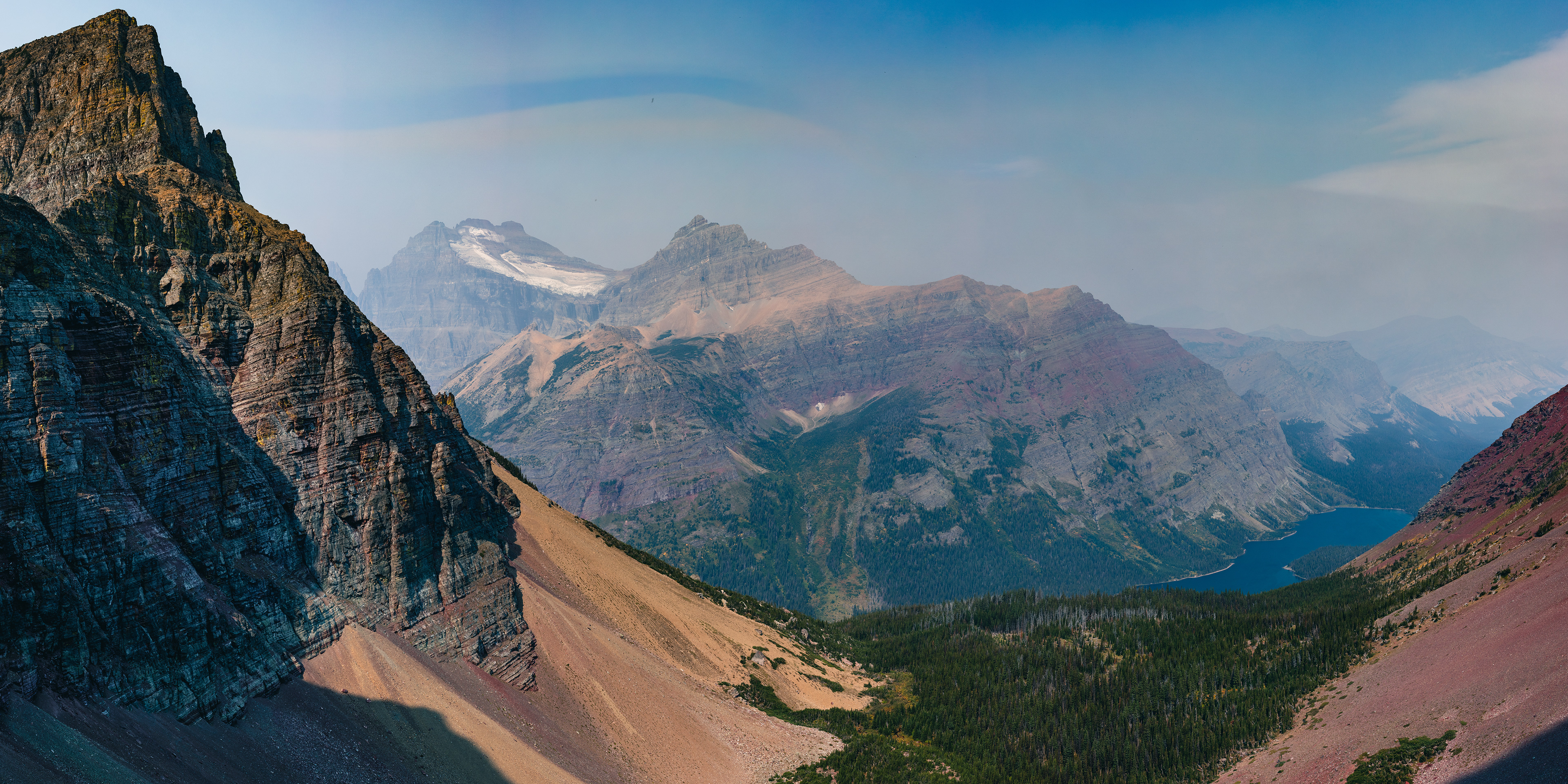 Landscape photograph of Mount Merritt, the Old Sun Glacier, and Natoas Peak in Glacier National Park, Montana, featuring glacial ice, steep peaks, and high alpine scenery.