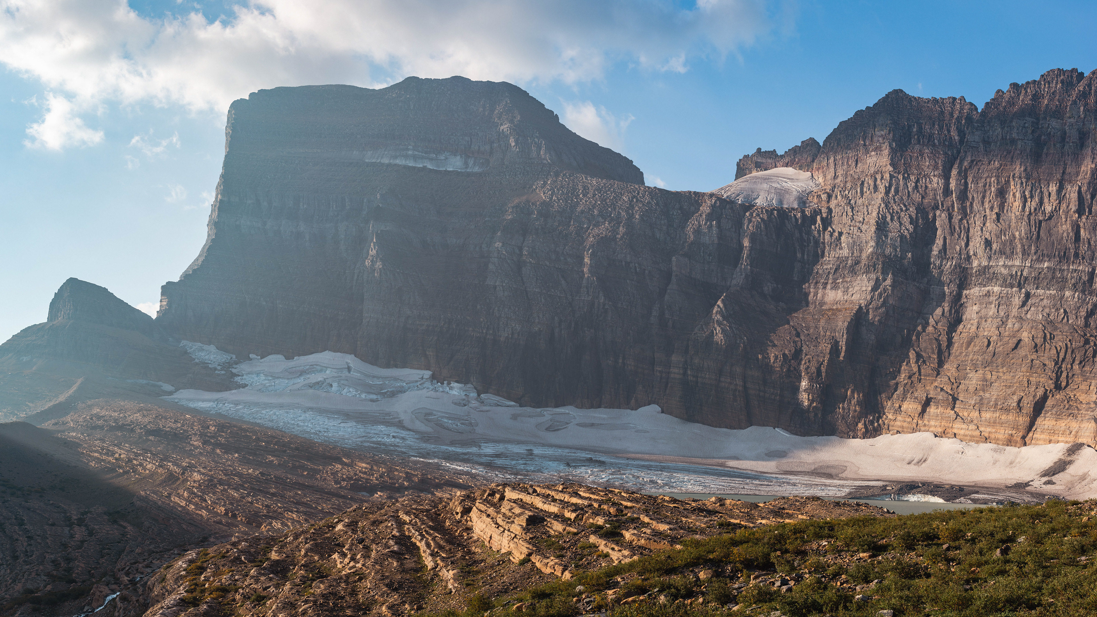 Photograph of Grinnell Glacier and Gem Glacier in Glacier National Park, with subtle light across the ice and surrounding alpine terrain