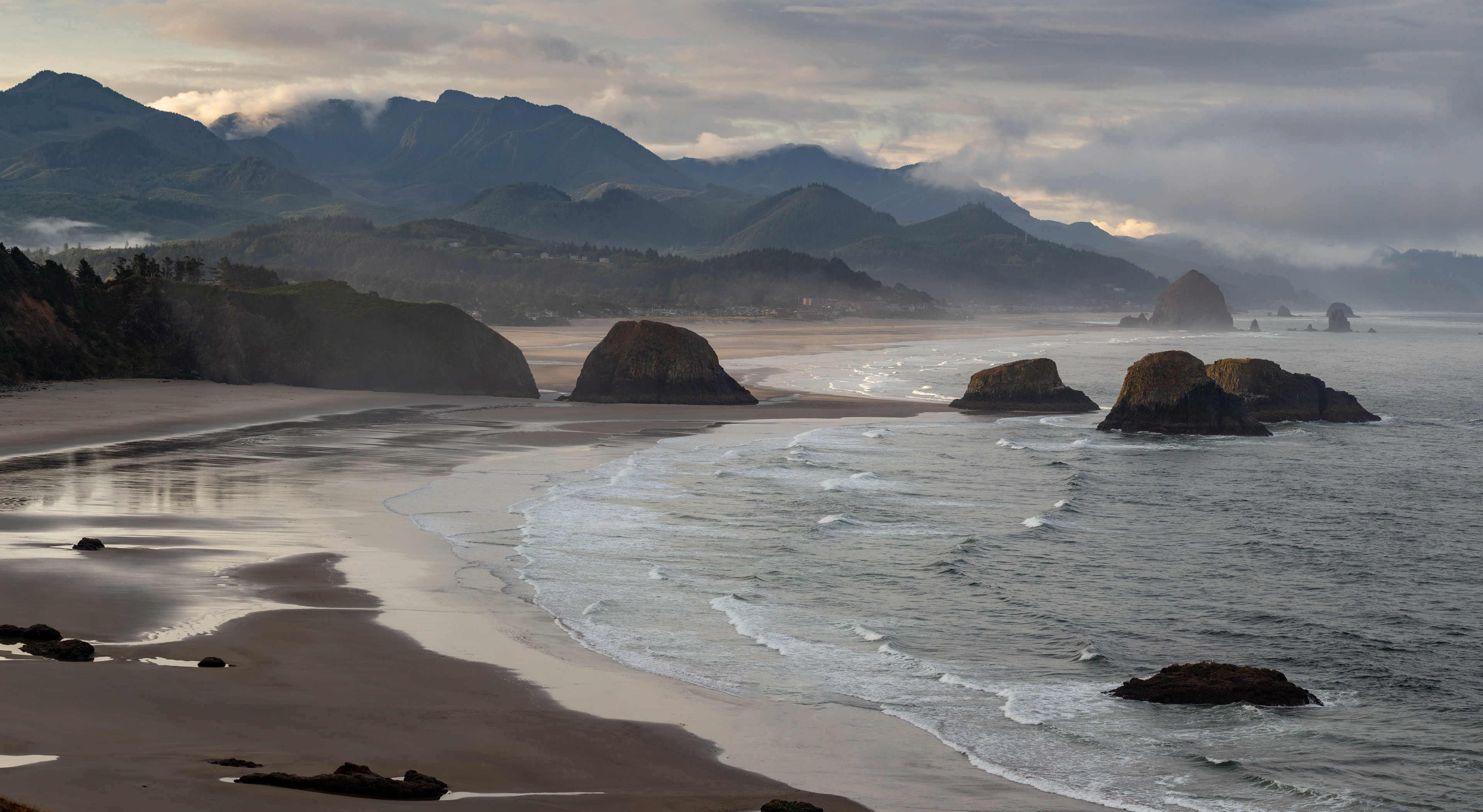 Photograph of Crescent Beach and Cannon Beach viewed from Ecola Point in Ecola State Park, Oregon, with rugged coastline, sea stacks, and sweeping Pacific Ocean views.