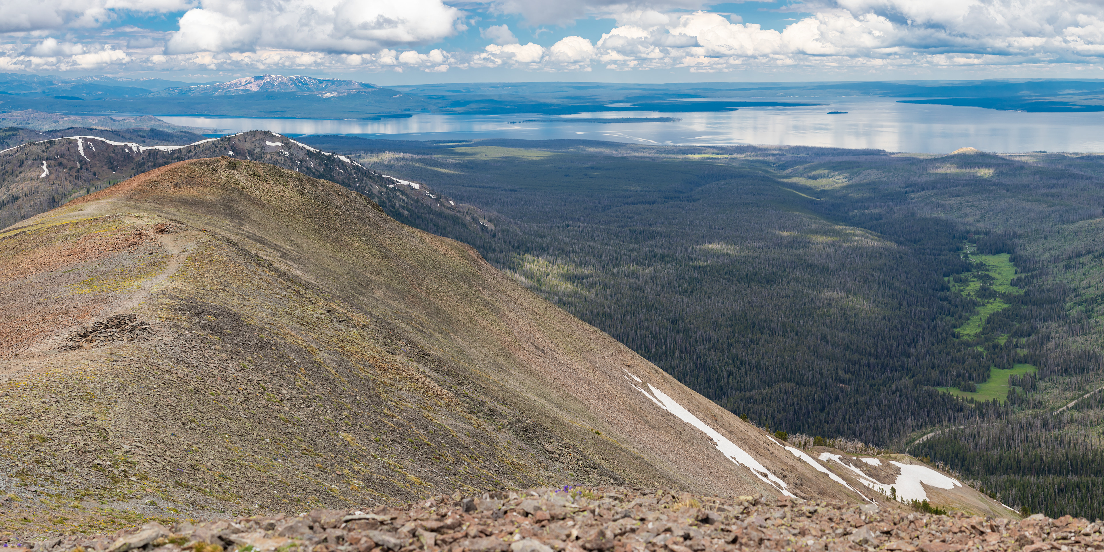 Photograph of the Avalanche Peak Trail in Yellowstone National Park, Wyoming, with steep alpine terrain, forested slopes, and expansive mountain views.
