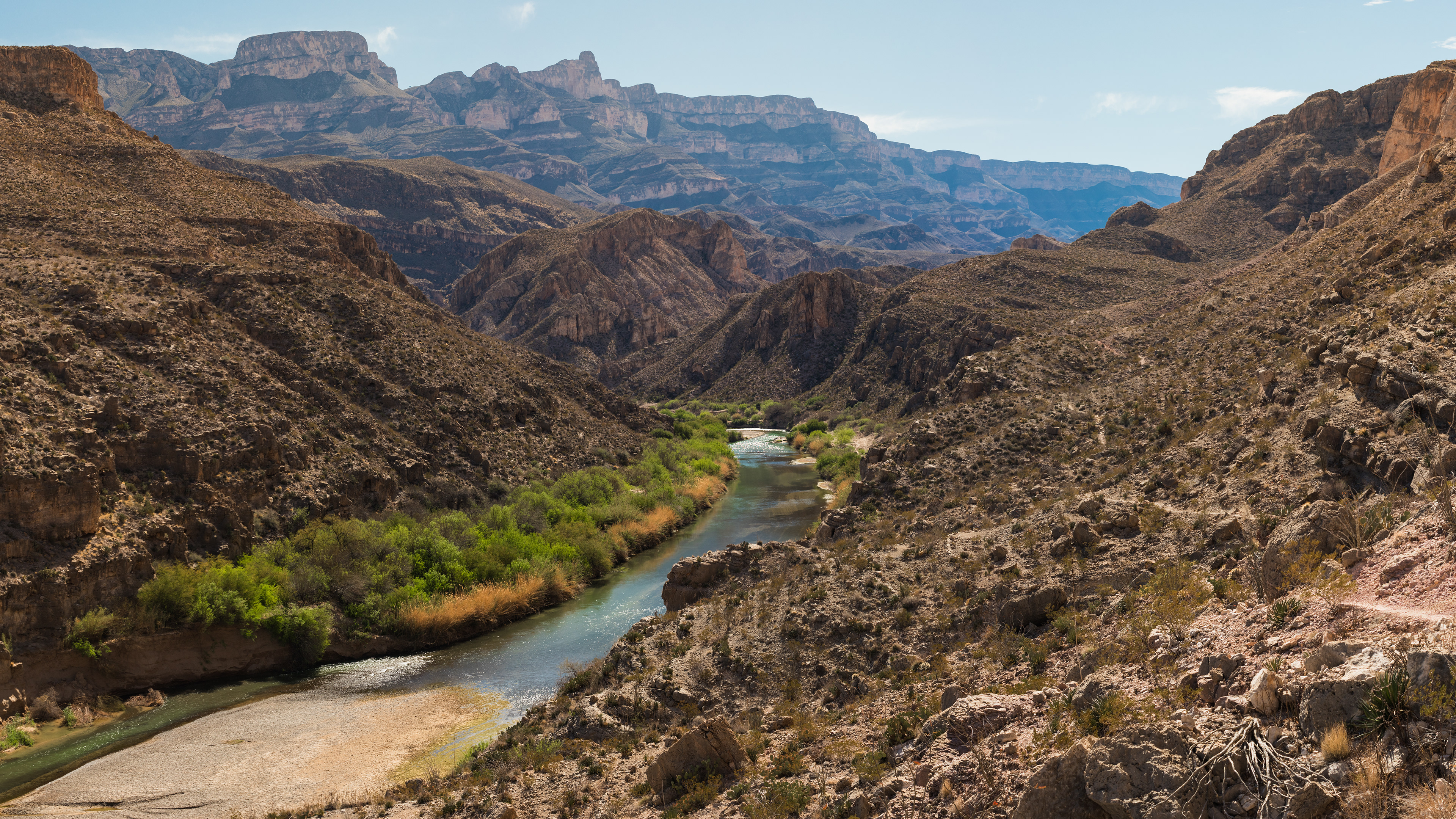 Photograph of the Rio Grande winding through Big Bend National Park, Texas, with a river corridor cutting through desert terrain and rugged canyon walls.