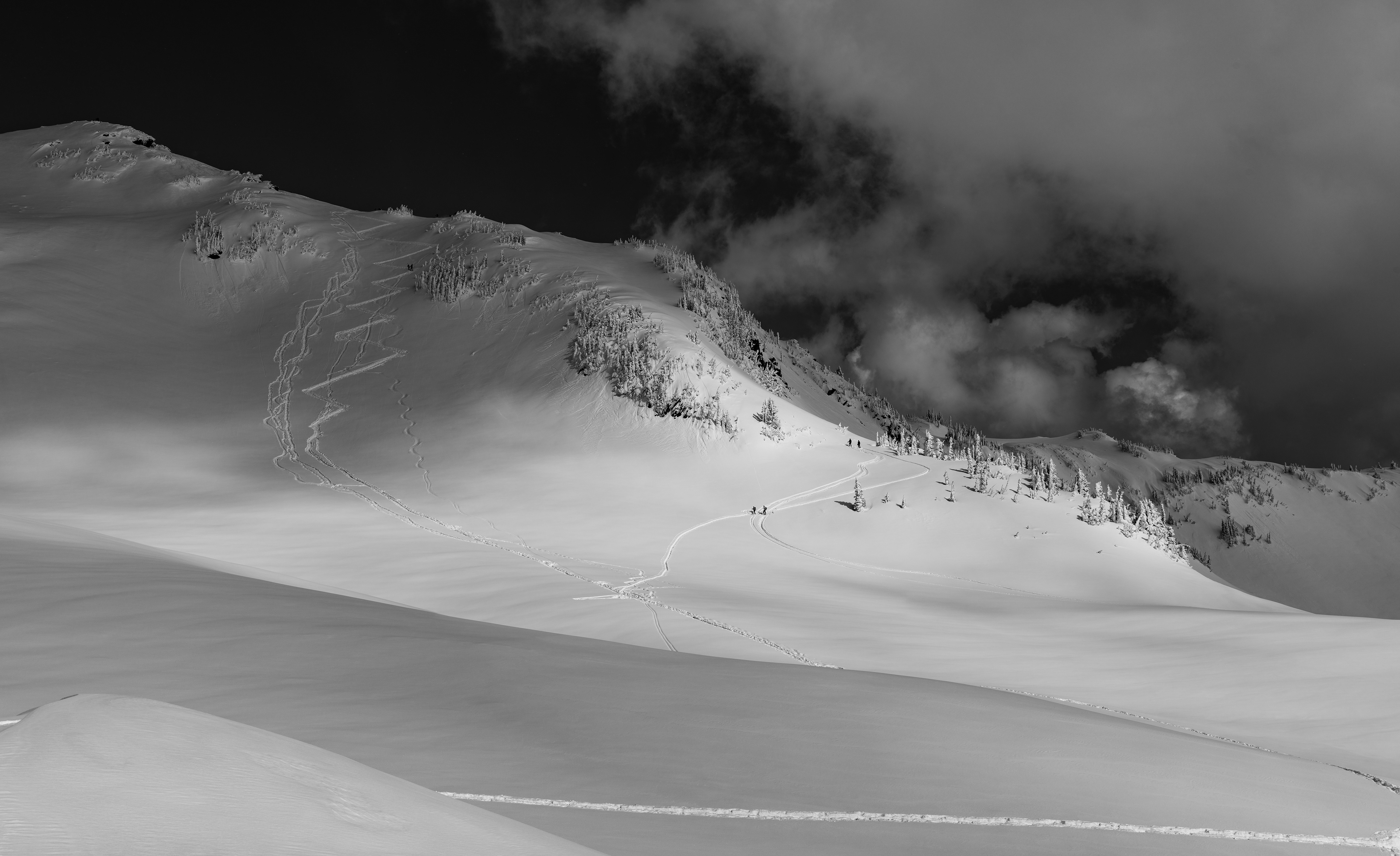 Black and white photograph of the Skyline Trail covered in snow in Mount Rainier National Park, Washington, with winter conditions and alpine terrain.