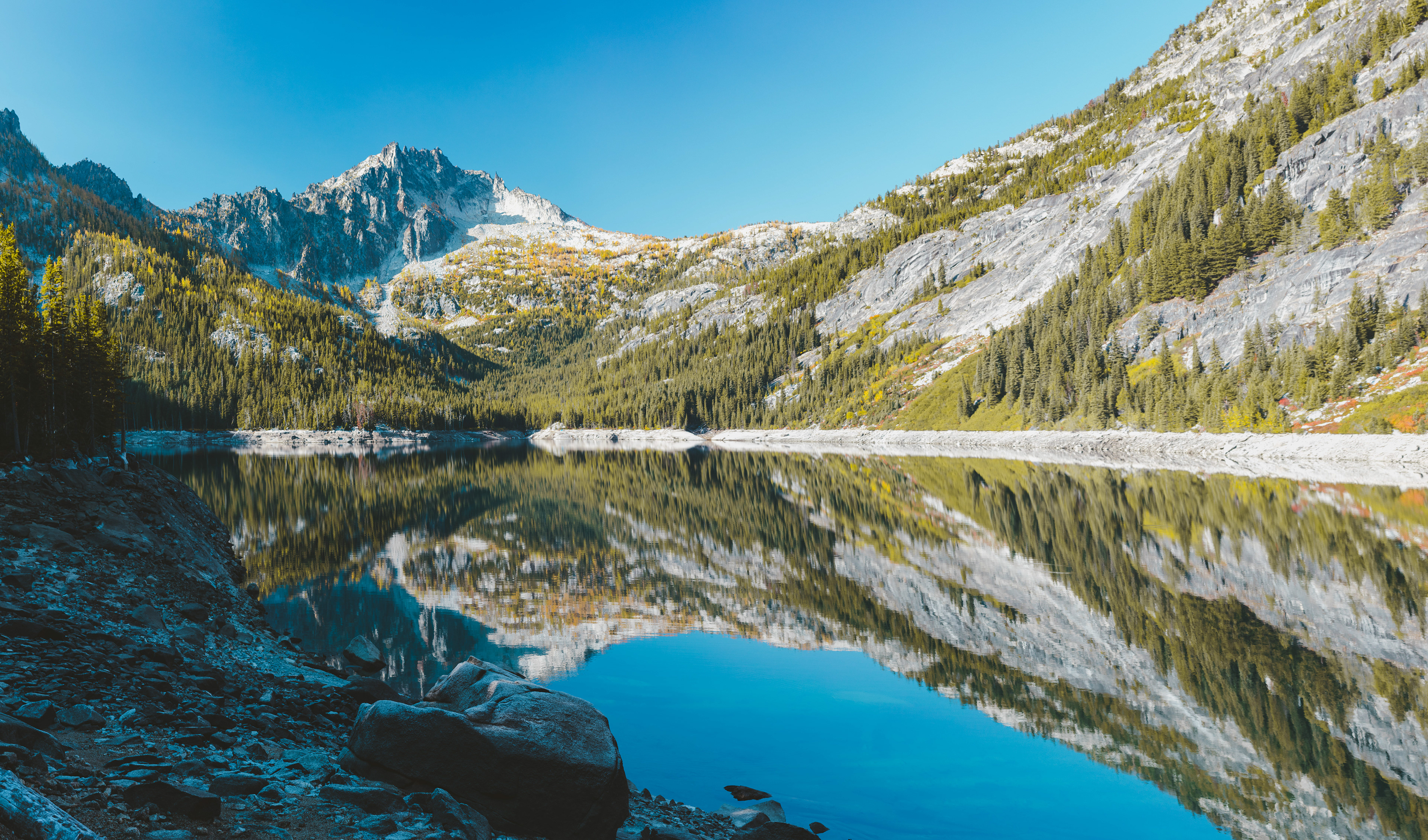 Photograph of Snow Lake in the Enchantments in the Alpine Lakes Wilderness, Washington, with clear alpine water and surrounding granite peaks.