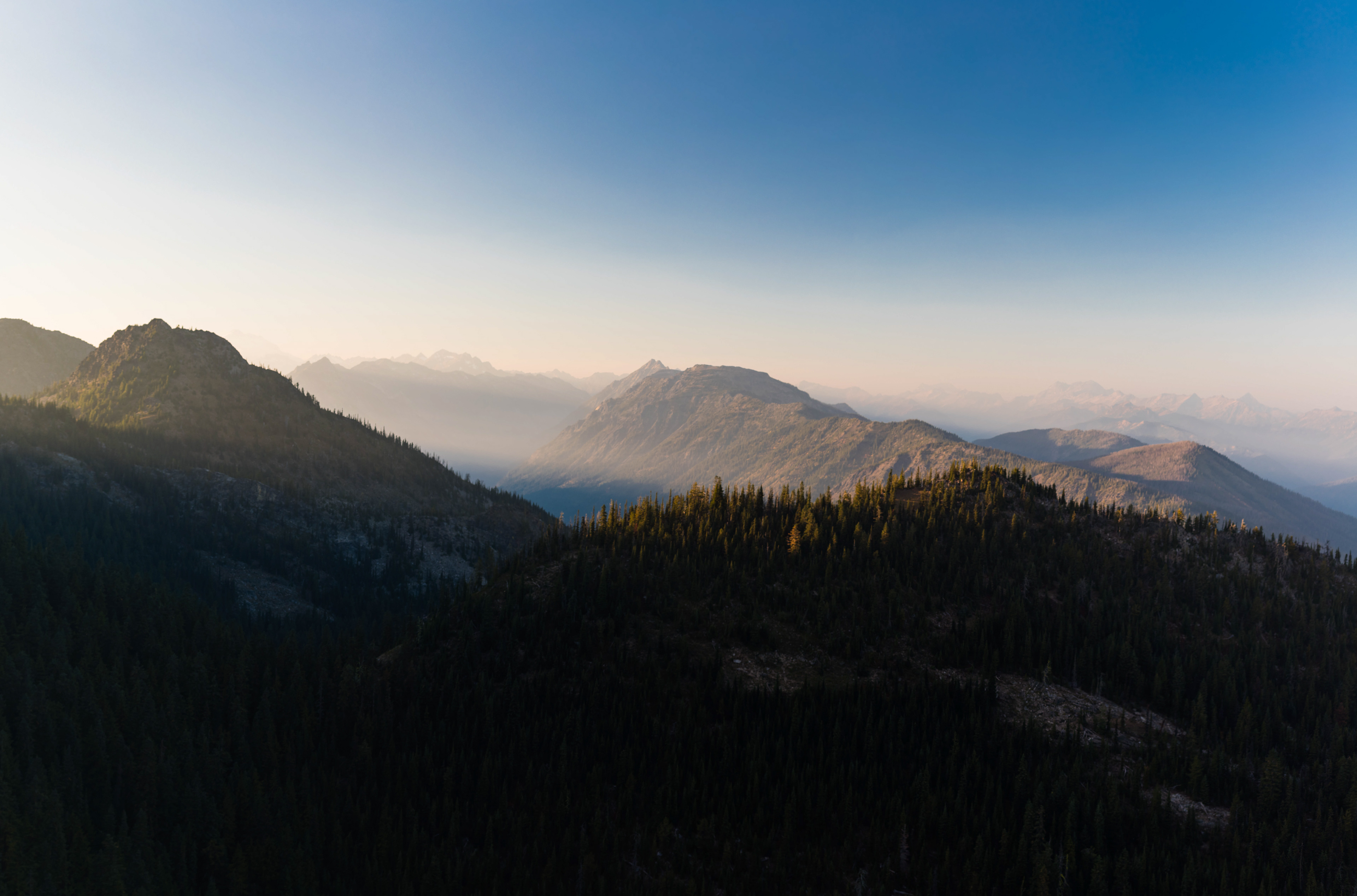 Photograph of Dirtyface Peak in the Okanogan-Wenatchee National Forest, Washington, with rugged alpine terrain and forested lower slopes.