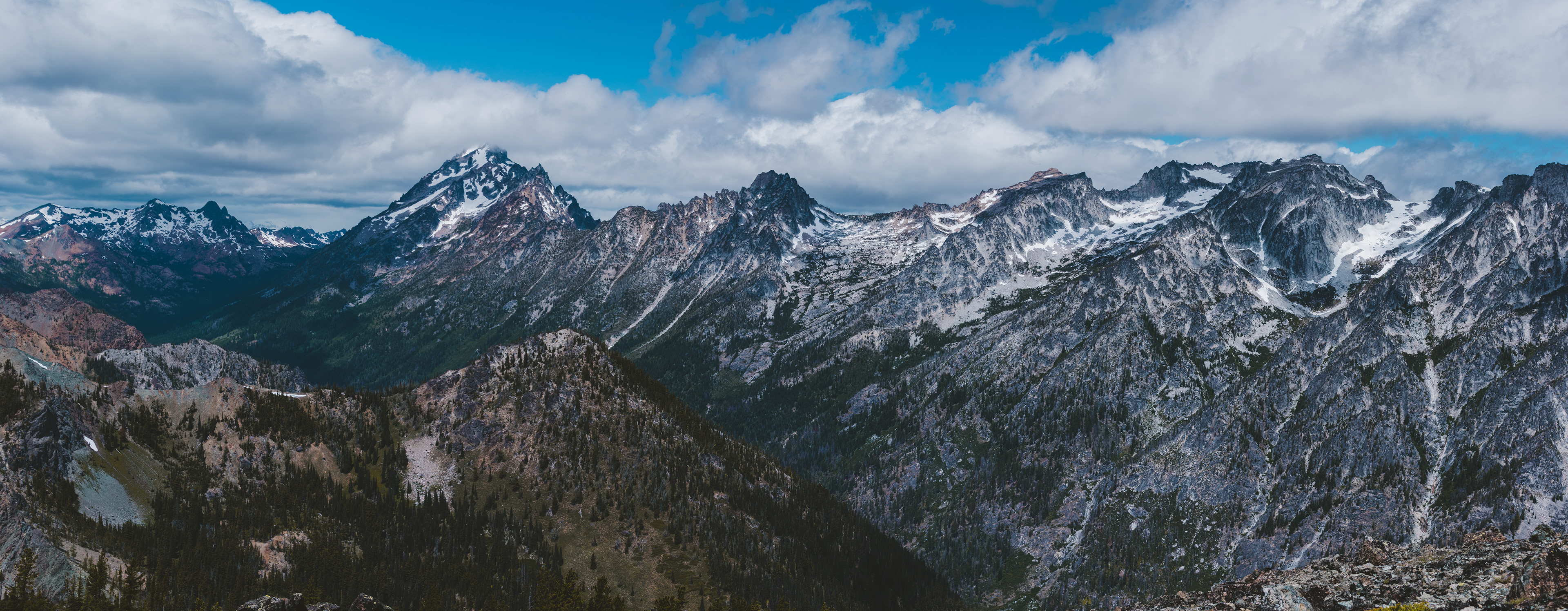 Photograph of the Enchantments viewed from Navaho Peak in the Alpine Lakes Wilderness, Washington, with granite basins, alpine lakes, and rugged mountain terrain.