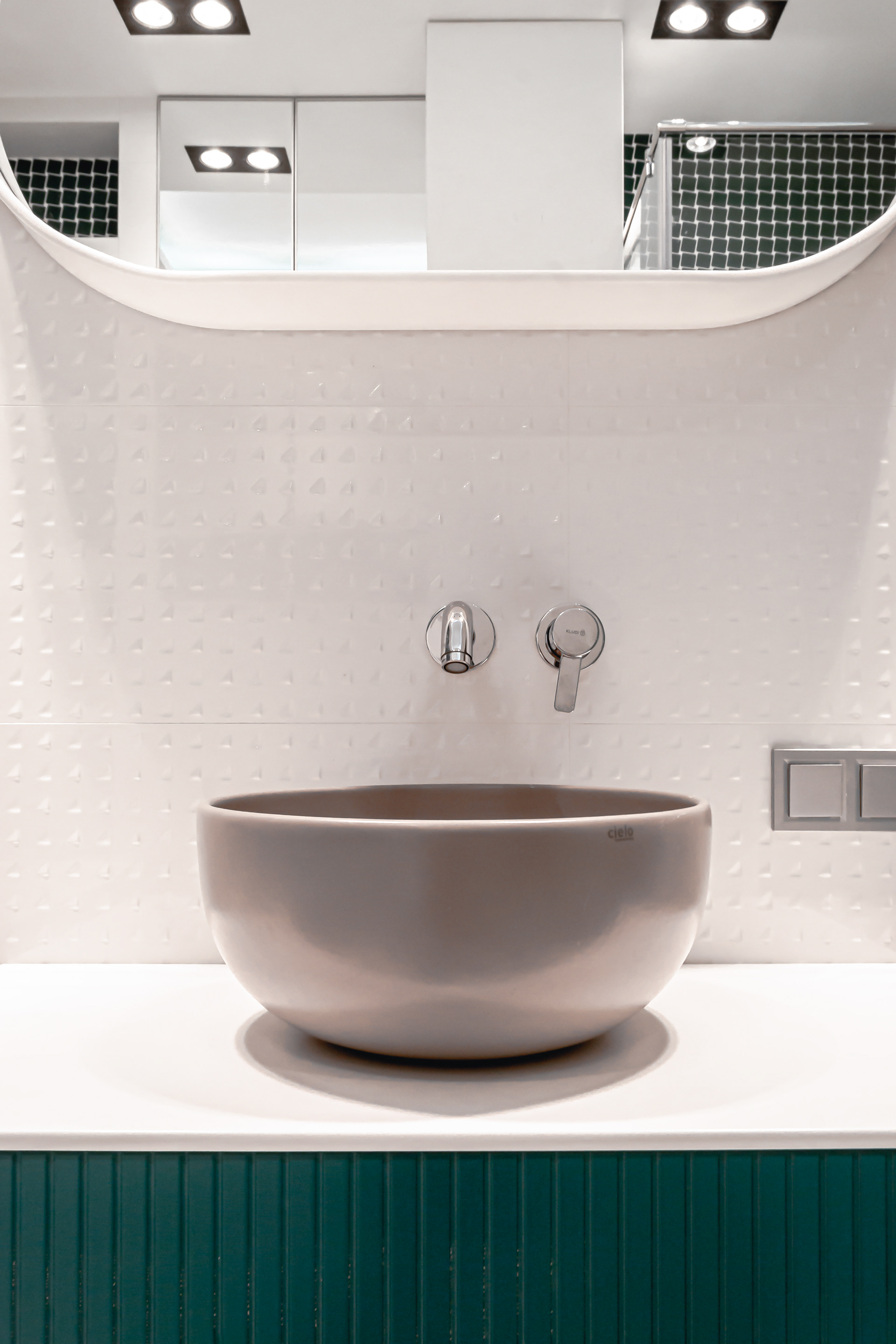 ceramic bowl sink mounted on top with wall mounted faucet