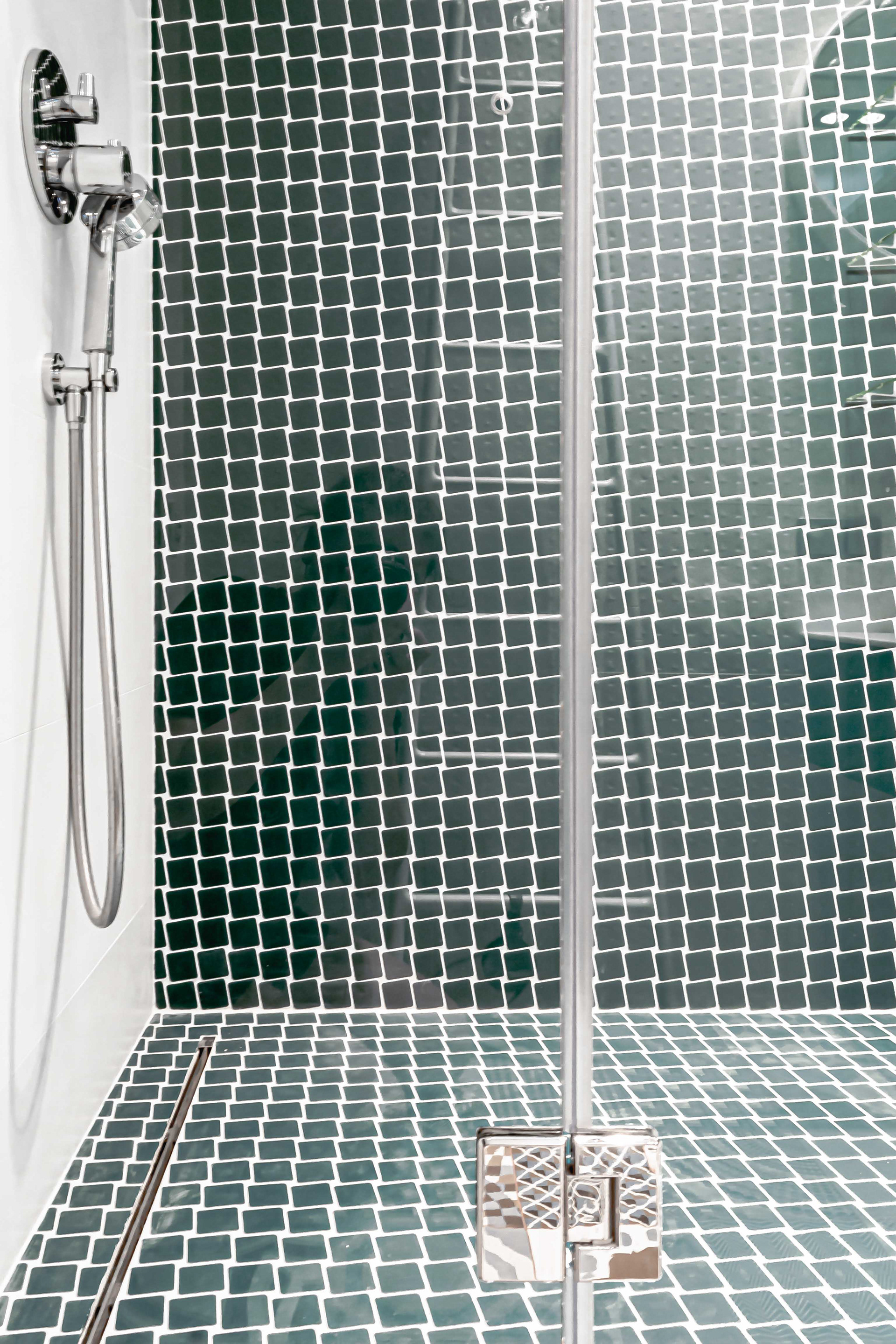 dark green mosaic-tiled shower