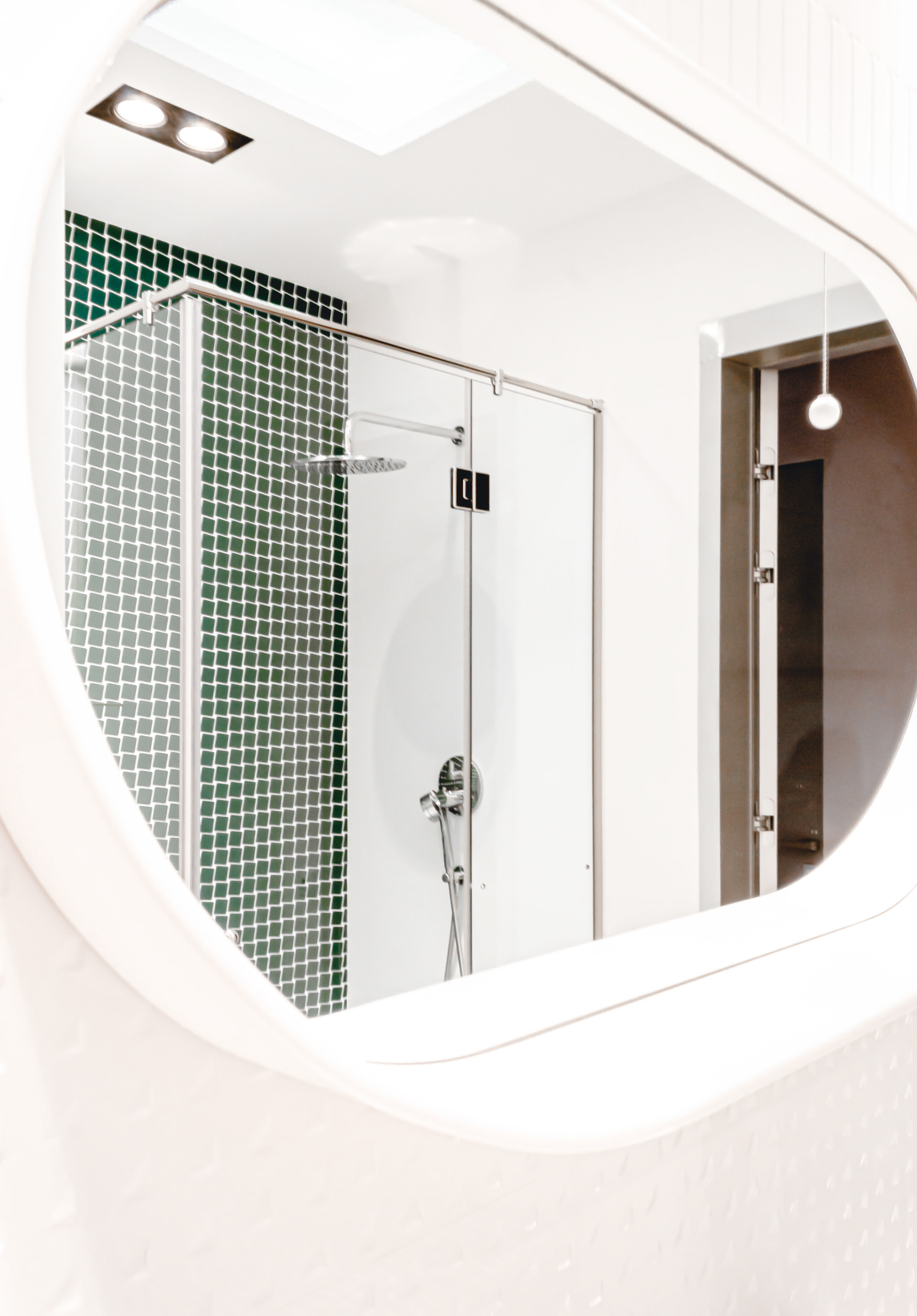 mirror with white metal frame with a shelf