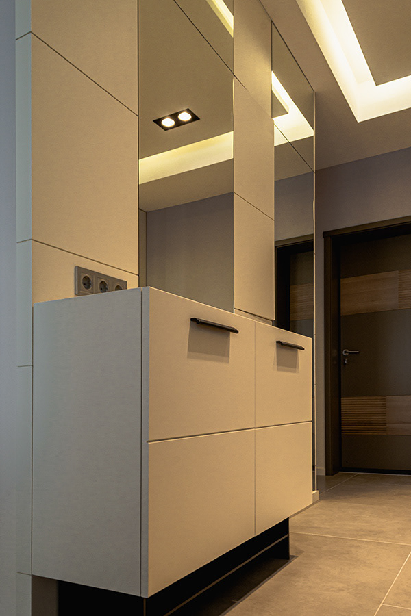 console and paneled wall with mirrors