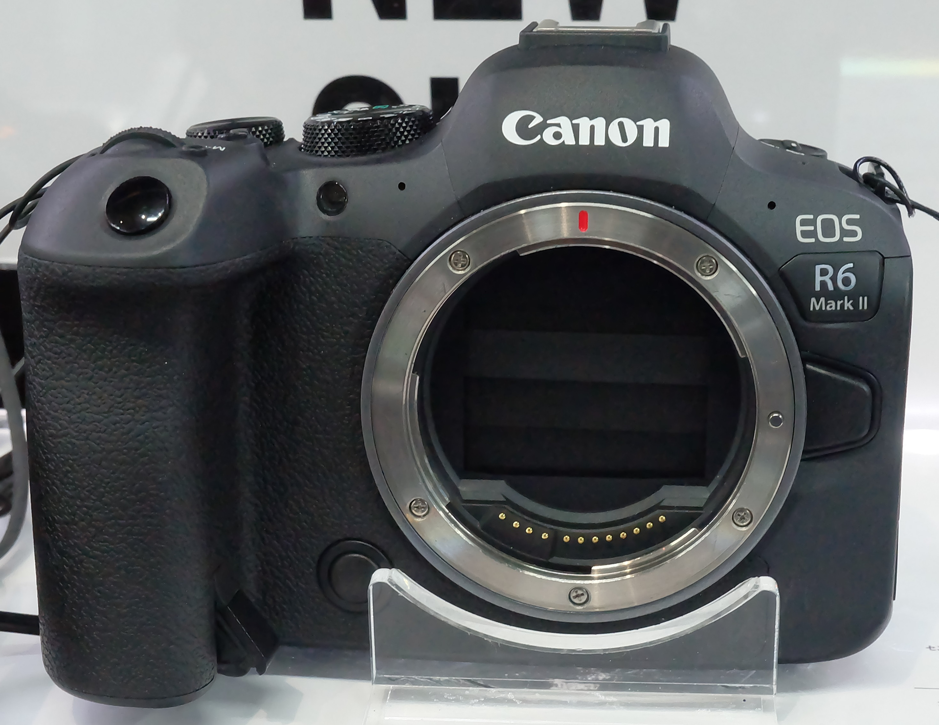 Close-up image of the Canon EOR R6 Mark 2 mirrorless camera from the front. No lens in attached.