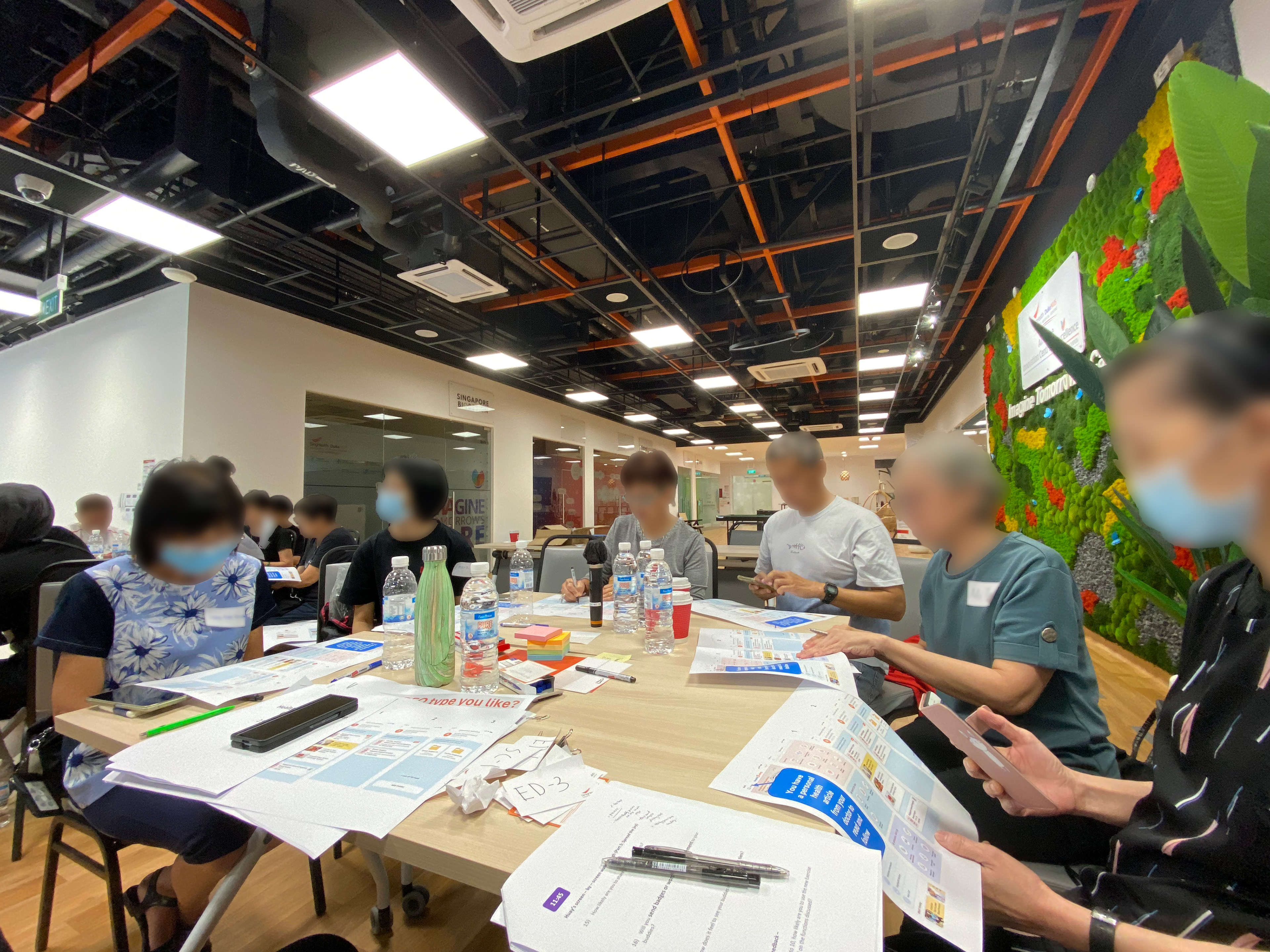Seniors sitting around a table doing testing on paper prototypes