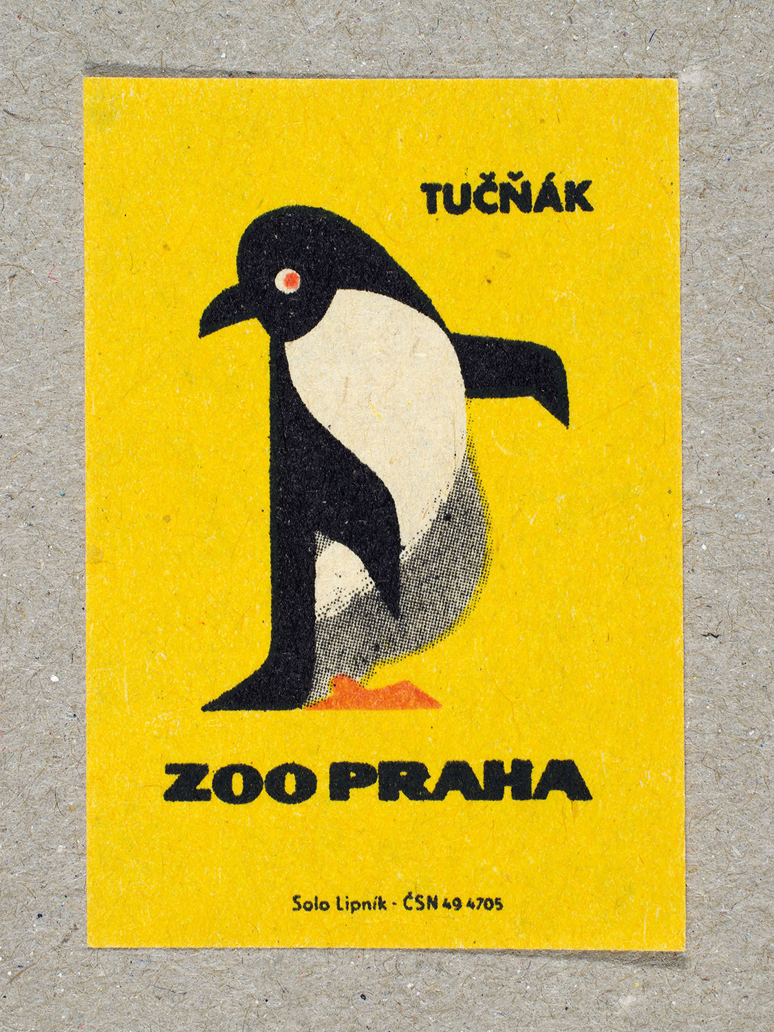Vintage 1963 Czech matchbox label by Solo Lipník featuring a penguin on a yellow background. Part of the 'Zoo Praha' series advertising Prague Zoo in Czechoslovakia.