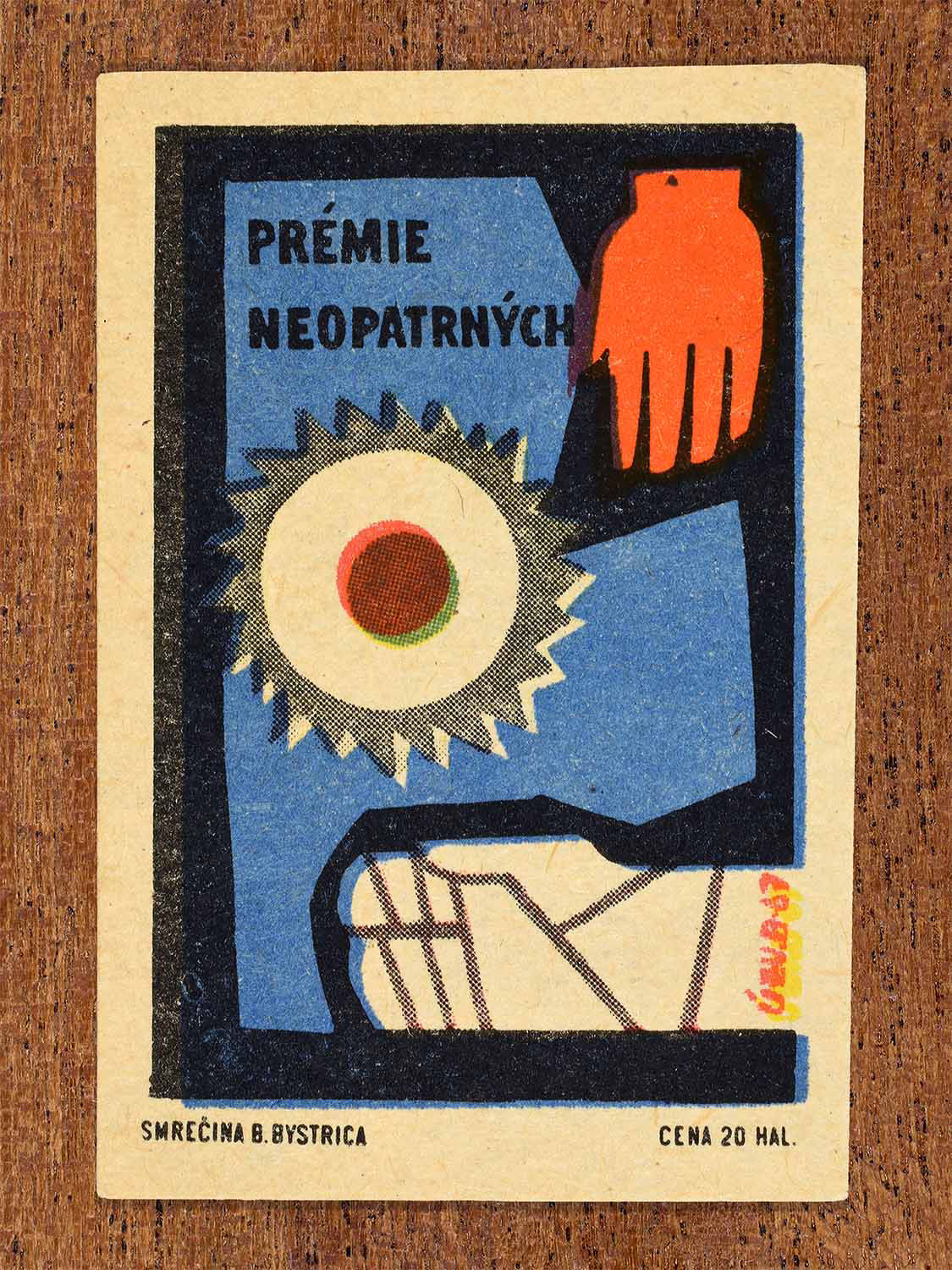 Vintage 1967 Czech matchbox label showing a bandaged hand and circular saw blade in blue and red colours. Produced by the Smrečná match factory, Banská Bystrica, to warn against careless behaviour leading to injury.