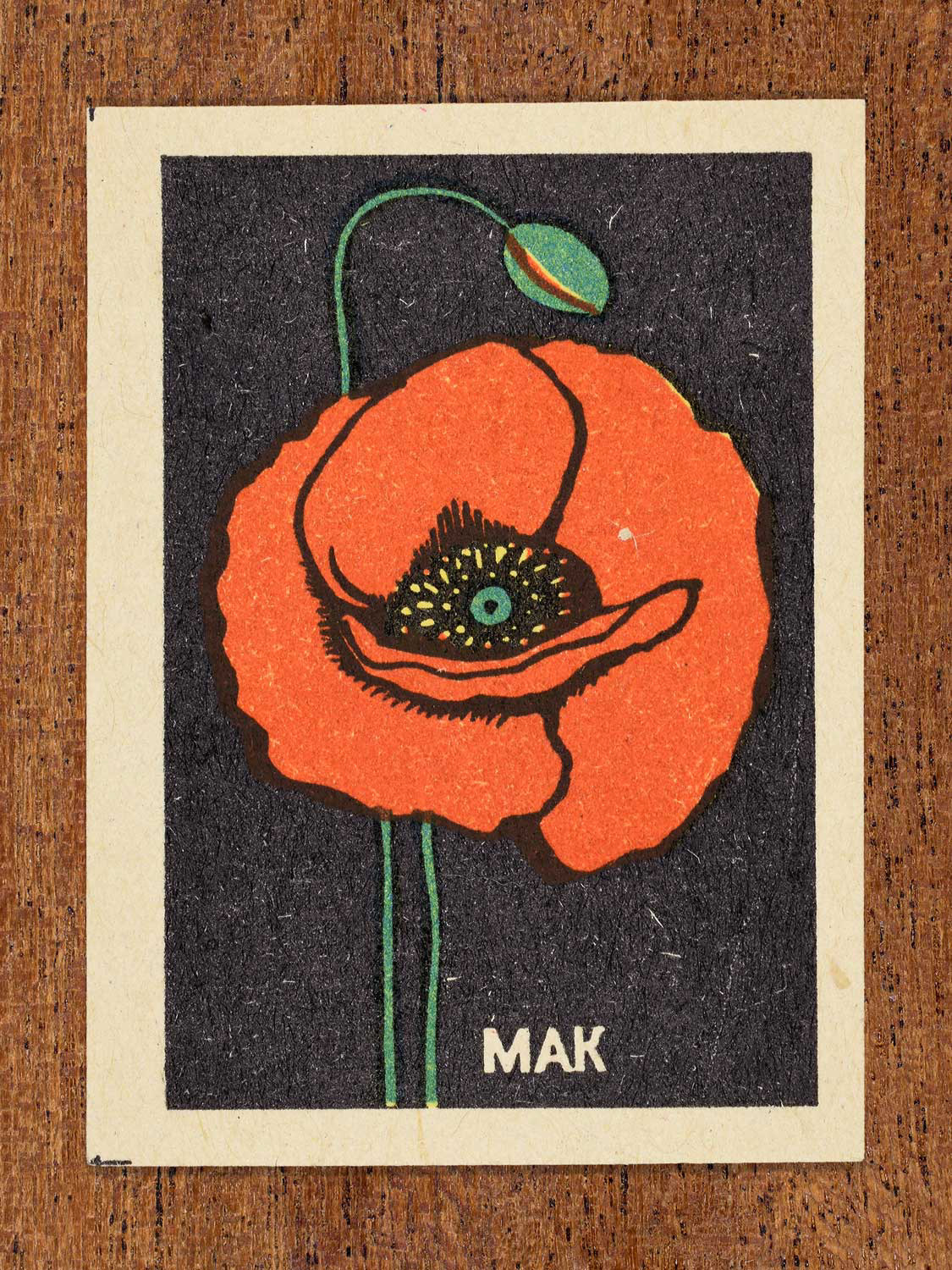 Vintage 1972 Soviet matchbox label showing a red poppy flower with green stem on a black background. Produced by the Balabanovskaya Experimental Match Factory in Balabanovo to promote botanical knowledge.