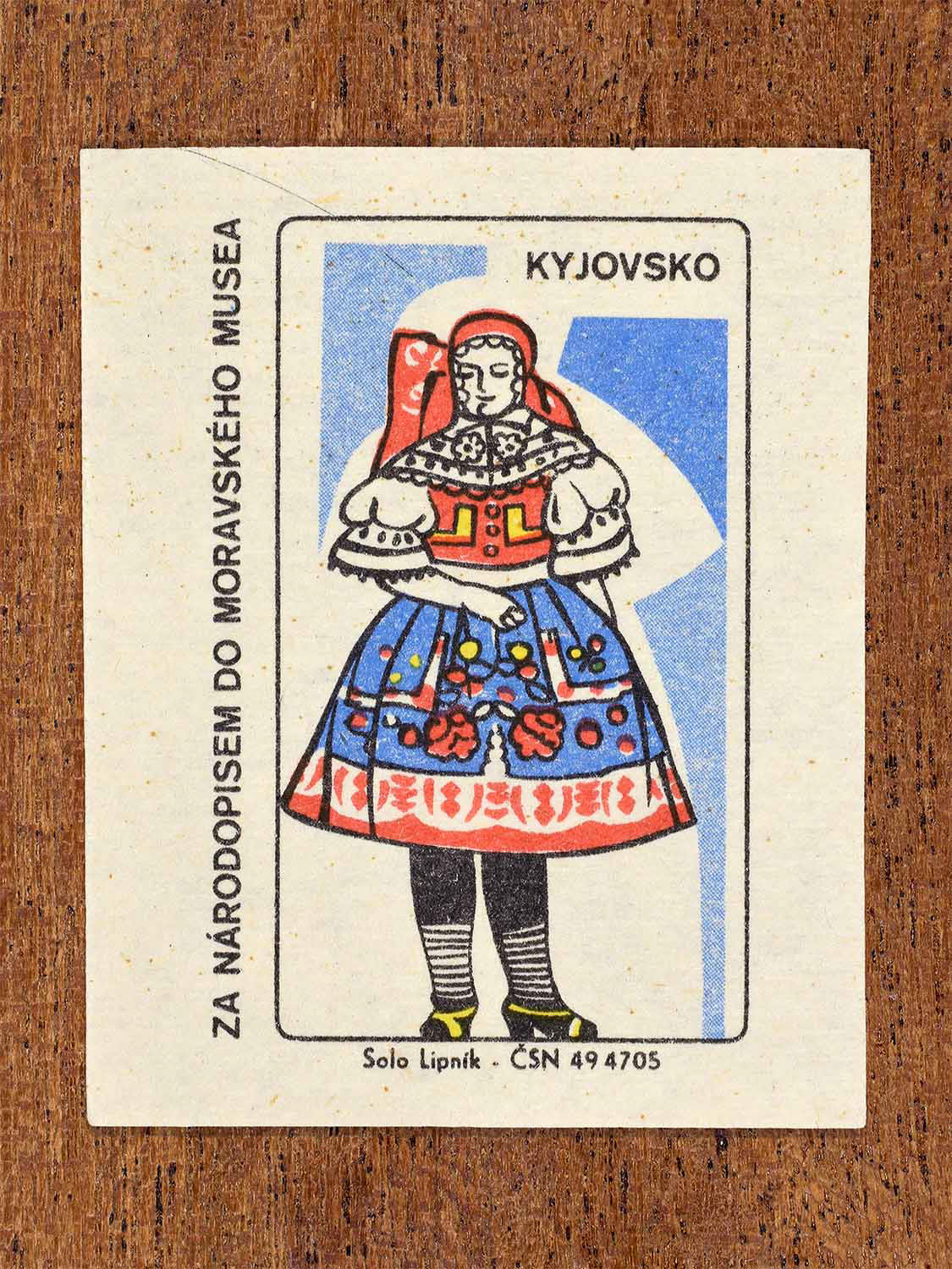 Vintage 1968 Czech matchbox label showing a female folk costume from the Kyjov region with richly embroidered skirt and bodice. Produced by the Solo Lipník match factory to promote Moravian ethnography through the Moravian Museum.