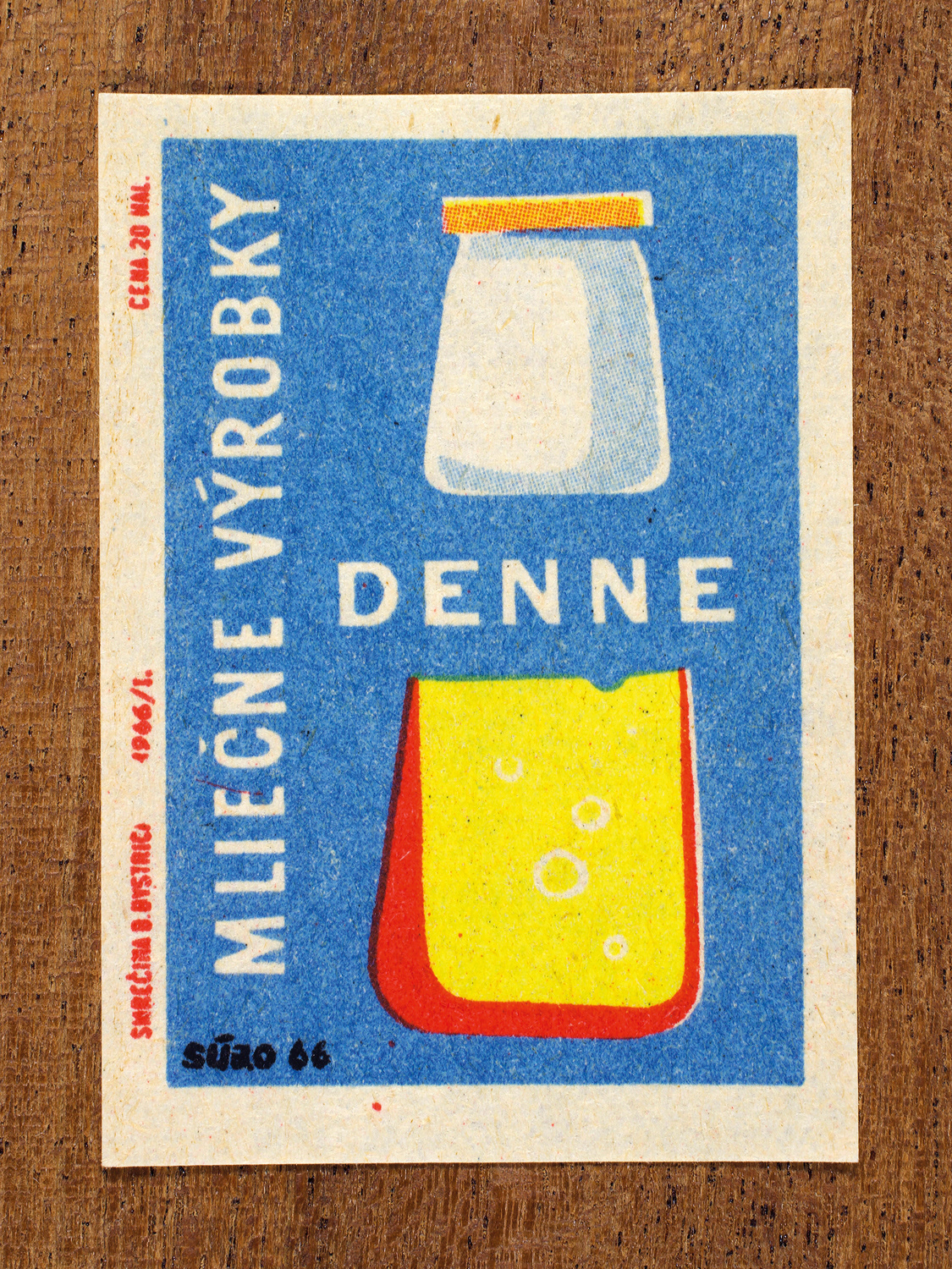 Vintage 1966 Czech matchbox label by Solo Smrečina B. Bystrica featuring a glass of milk and cheese on blue background. It promotes including dairy in your daily diet.