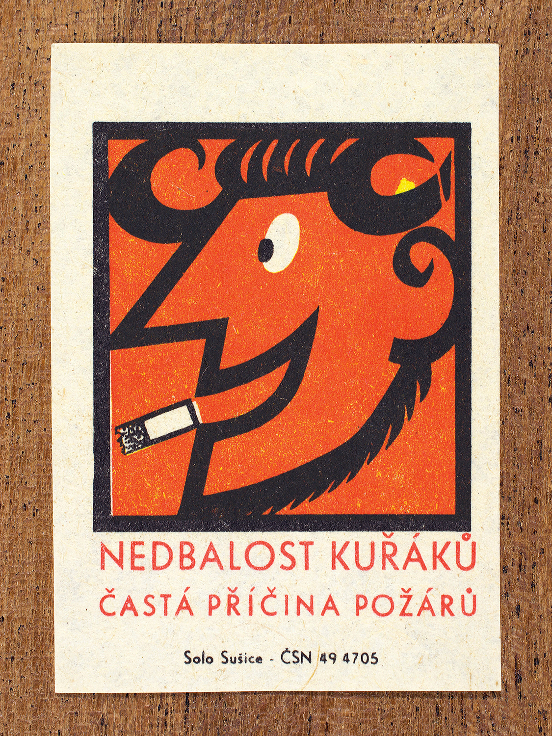 1968 Czechoslovak matchbox label by Solo Sušice showing a grinning devil with a cigarette in its mouth. Used as a public service message reminding people of their responibilty when smoking. Label 4 of 10 in the Fire Hazards Series.