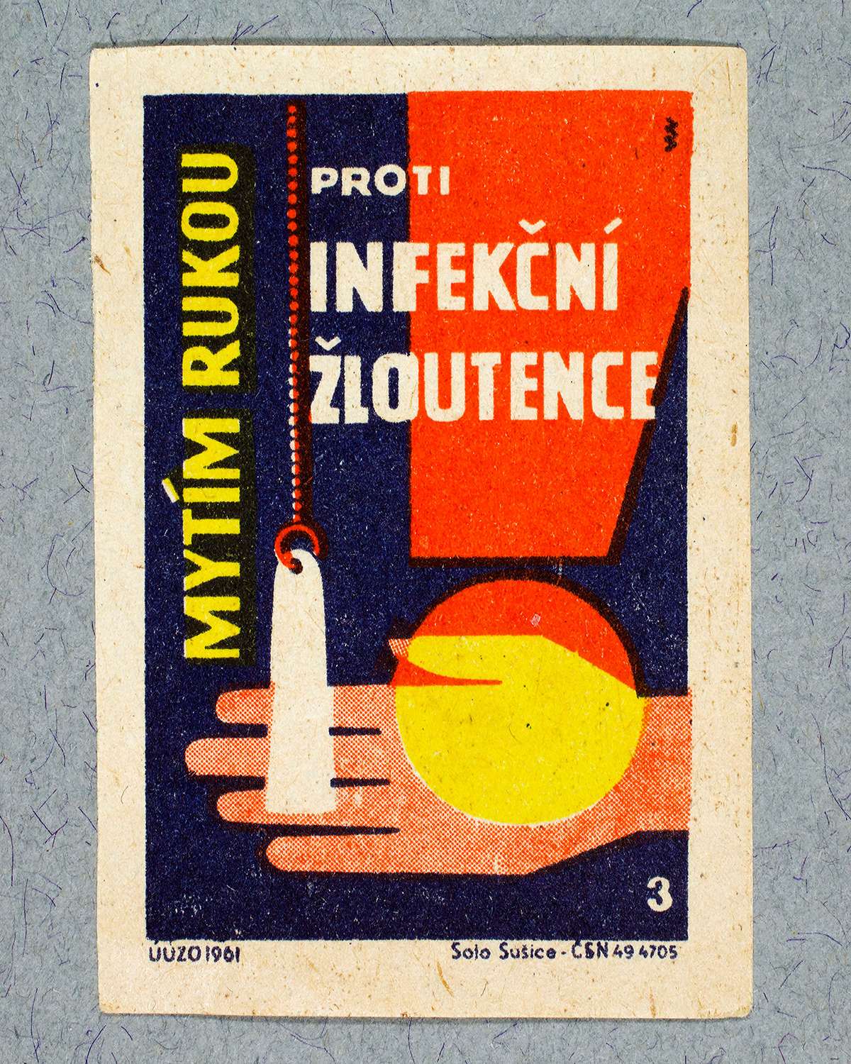 1961 Czech matchbox label by Solo Sušice showing a hand holding a bar of soap on a chain and a large red exlamation mark. Used as a public service message urging the public to fight infection by washing their hands.
