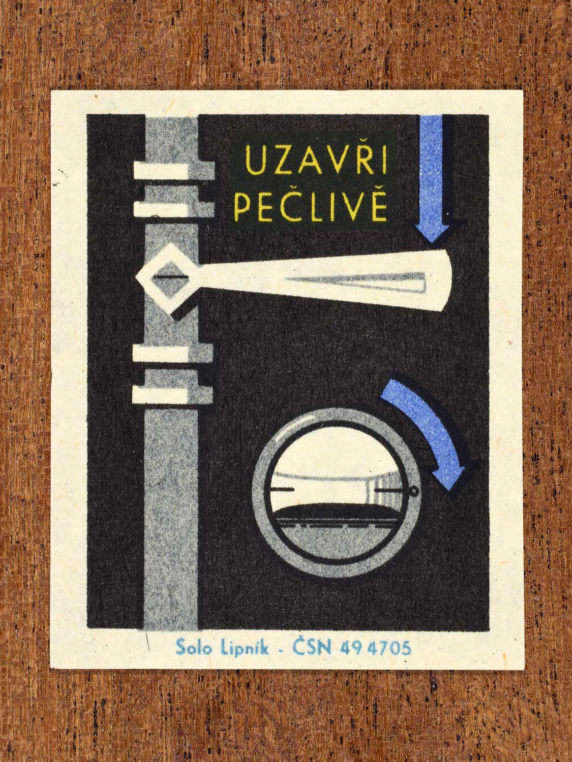 Vintage c. 1966 Czech matchbox label showing a pipe and two gas valves with directional arrows, in blue, yellow and black colours. Produced by the Solo Lipník match factory to promote safe, modern, and responsible domestic propane–butane gas use.