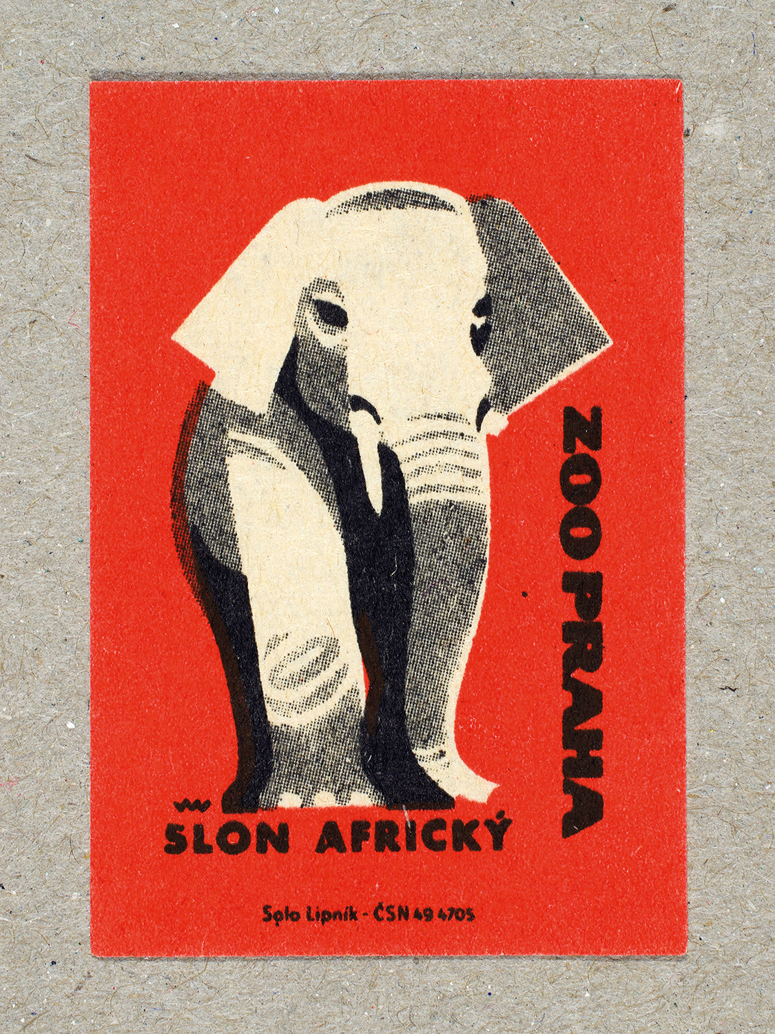 Vintage 1963 Czech matchbox label by Solo Lipník featuring a elephant on a red background. Part of the 'Zoo Praha' series advertising Prague Zoo in Czechoslovakia.