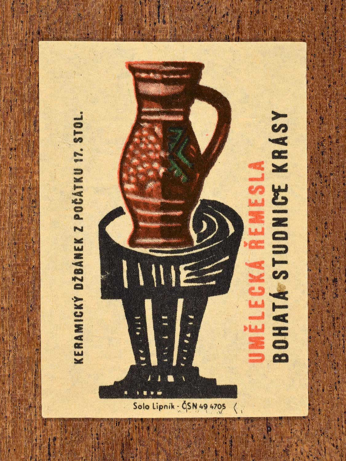 Vintage 1964 Czech matchbox label showing showing a 17th-century ceramic jug displayed as an art object. Produced by the Solo Lipník match factory to celebrate historic artistic crafts.