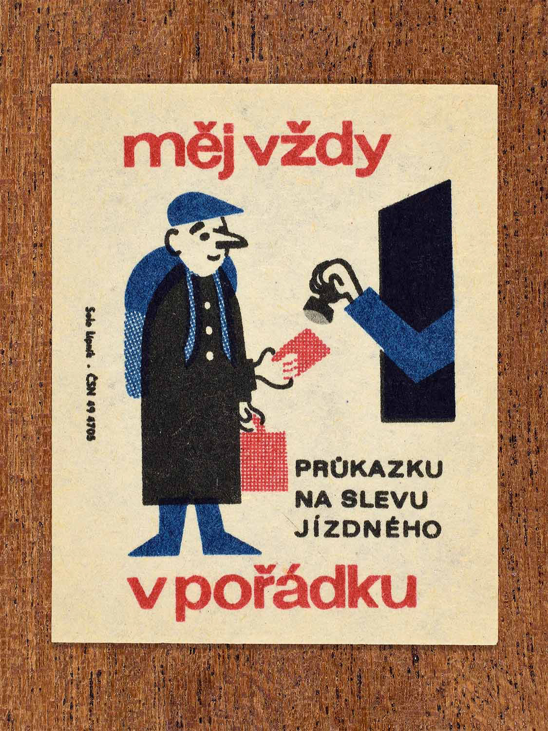 Vintage c. 1964 Czech matchbox label showing a railway passenger presenting a discount travel card to an inspector, illustrated in blue, red and black. Produced by the Solo Lipník match factory to promote proper documentation when travelling by train.