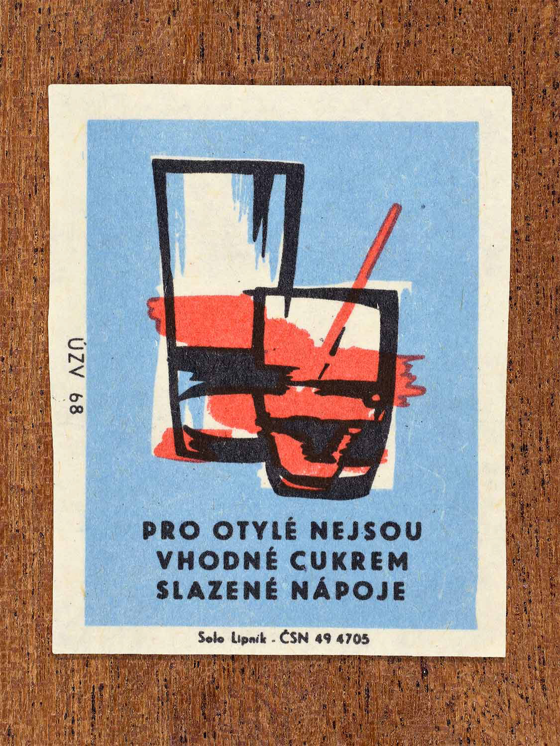 Vintage c. 1968 Czech matchbox label showing glasses of sweetened drinks. Produced by the Solo Lipník match factory to warn against sugar-sweetened beverages for overweight people.