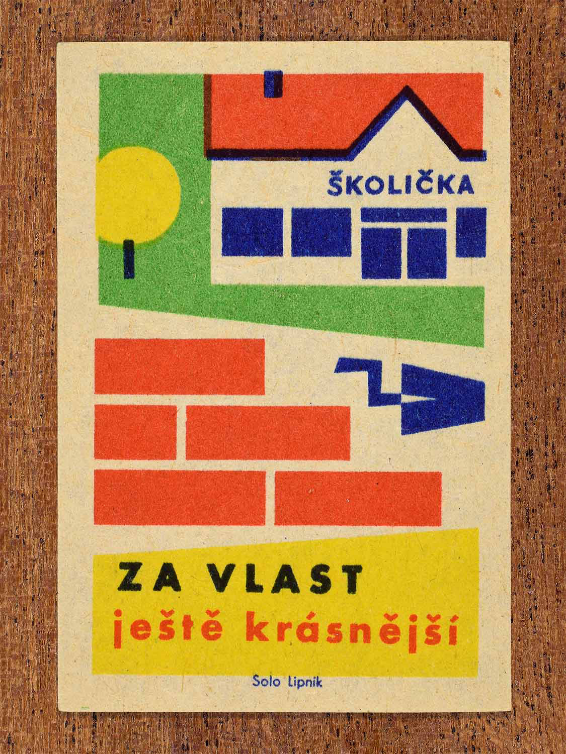 Vintage 1960 Czech matchbox label showing a stylised school, brick wall and construction trowel in red, blue, yellow and green colours. Produced by the Solo Lipník match factory to promote public building improvements and community.