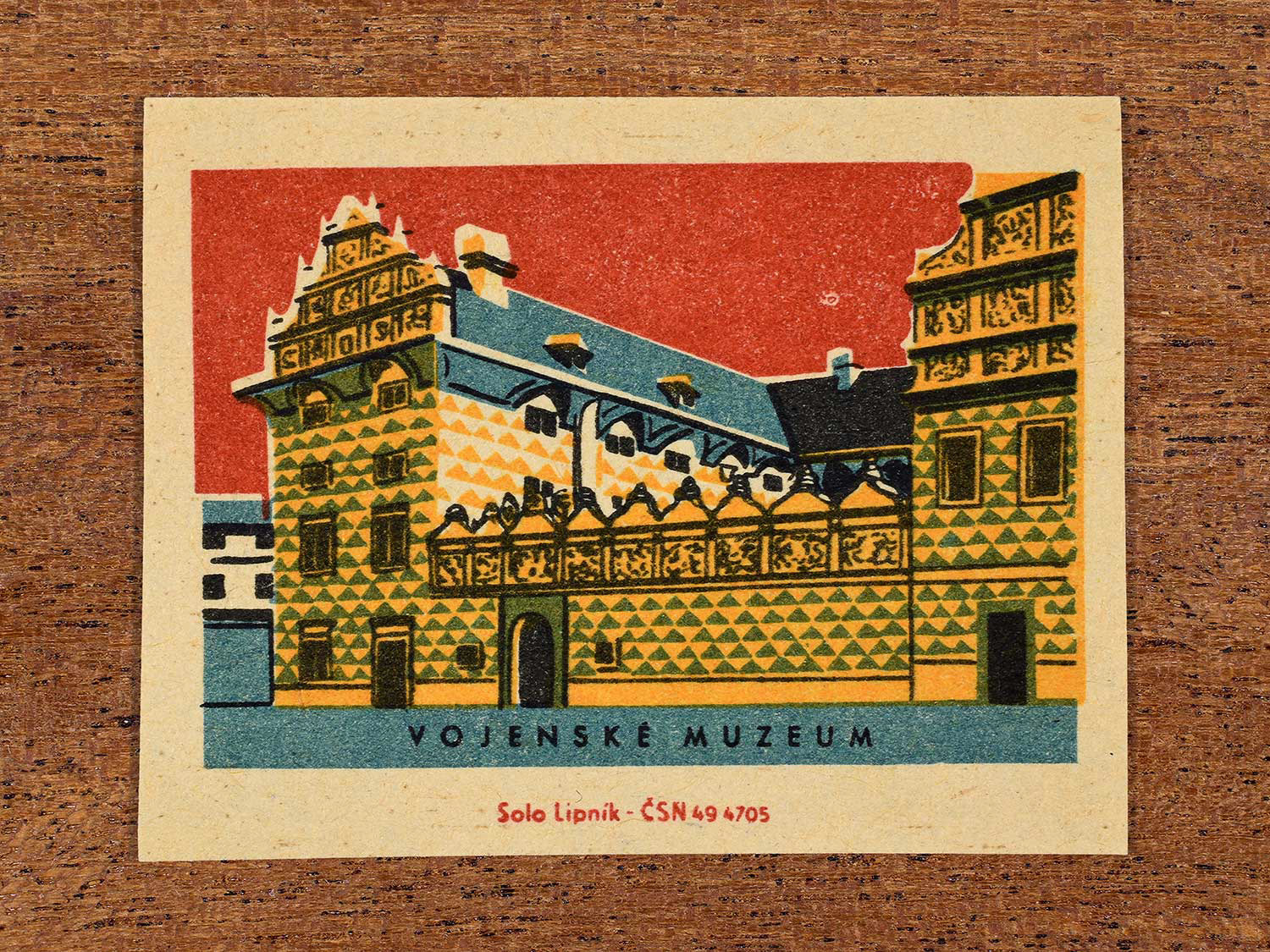 Vintage 1964 Czechoslovakia matchbox label showing the Vojenské Muzeum (Military Museum) in yellow, red and teal colours. Produced by the Solo Lipník match factory to promote domestic historical heritage and municipal institutions across the state.