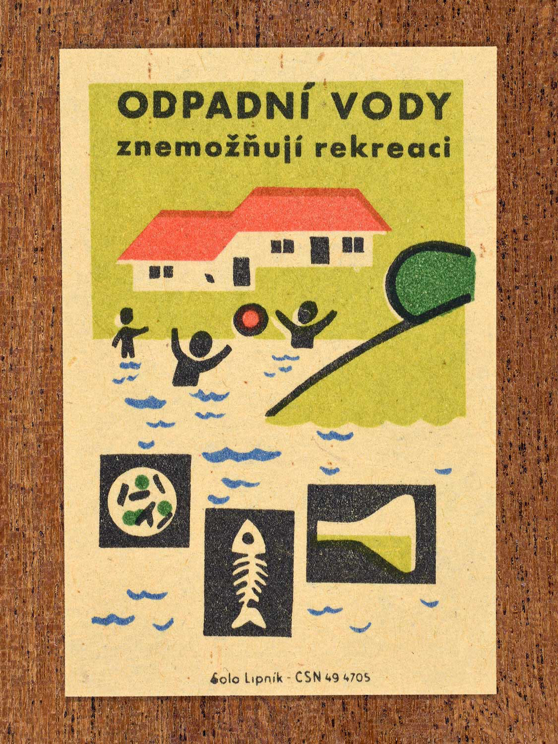 Vintage c. 1963 Czech matchbox label showing a house by the water with swimmers nearby, alongside icons of pollution, in green, red and black colours. Produced by Solo Lipník match factory warning that wastewater makes recreation impossible.