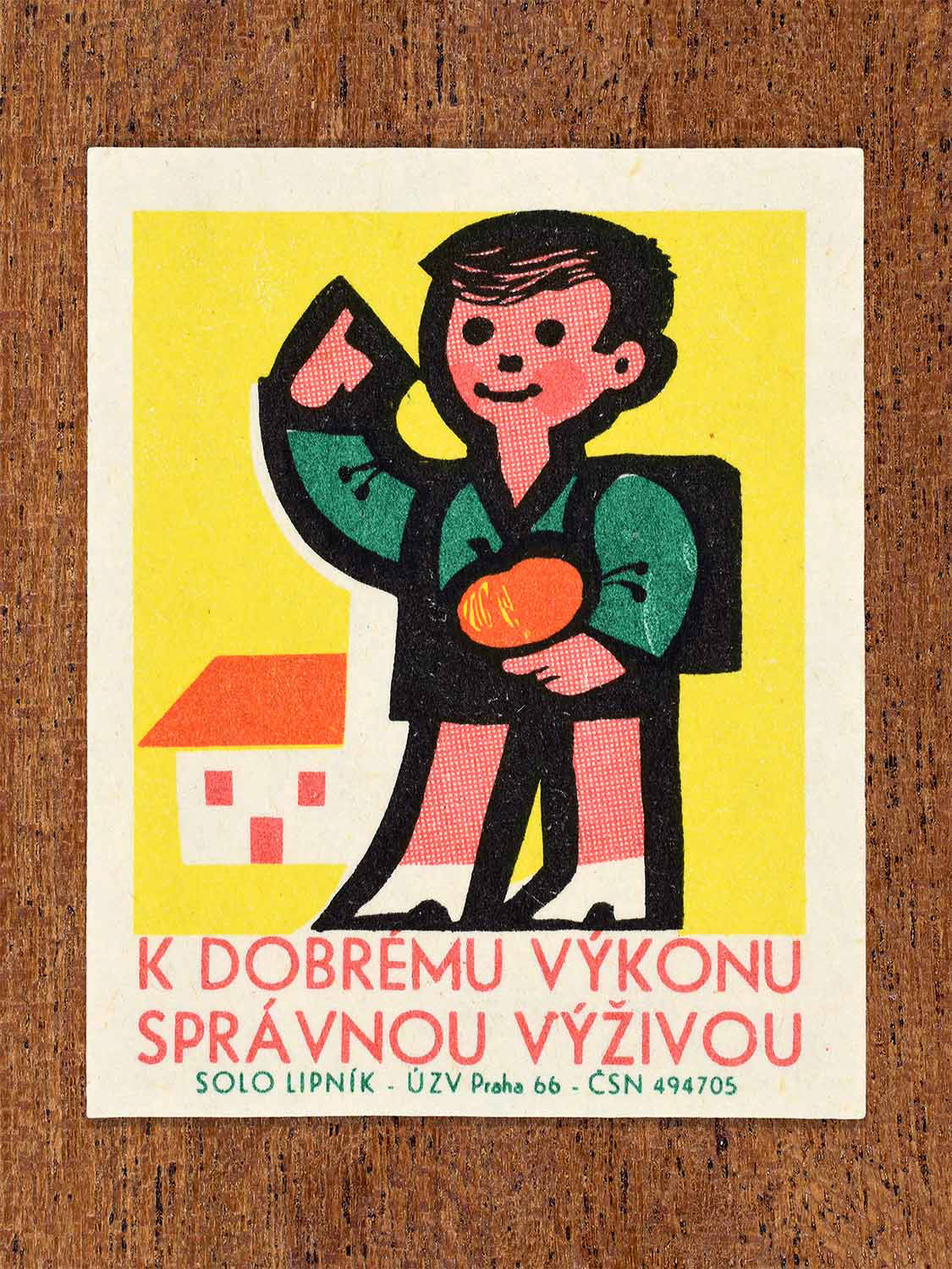 Vintage 1966 Czech matchbox label showing a schoolboy with a backpack holding an apple. Produced by the Solo Lipník match factory to promote healthy eating for children’s performance.