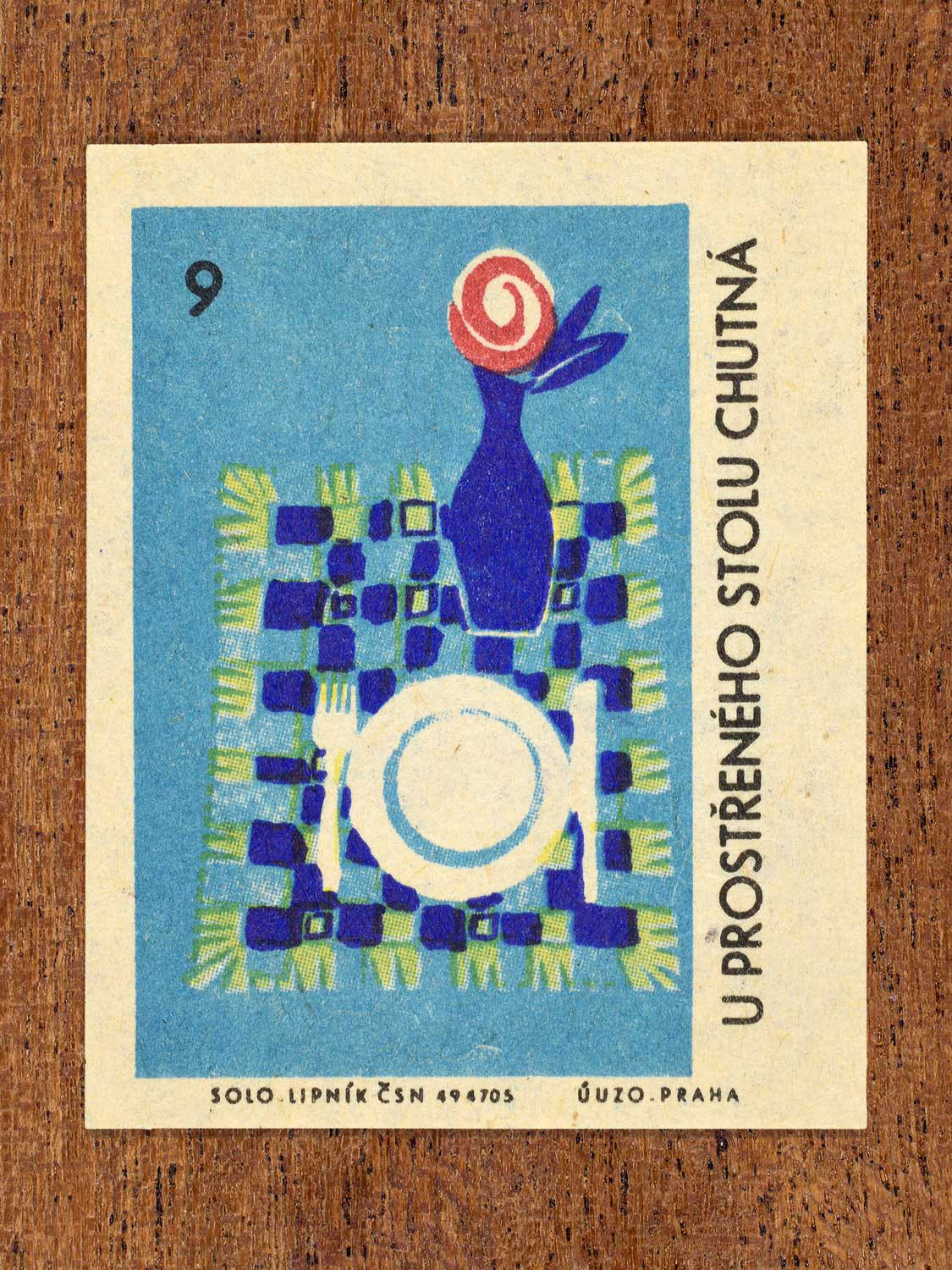 Vintage c. 1965 Czech matchbox label showing a neatly arranged place setting with a vase on a tablecloth. Produced by Solo Lipník match factory to promote the health benefits proper nutrition, daily meal routines, and everyday household habits.