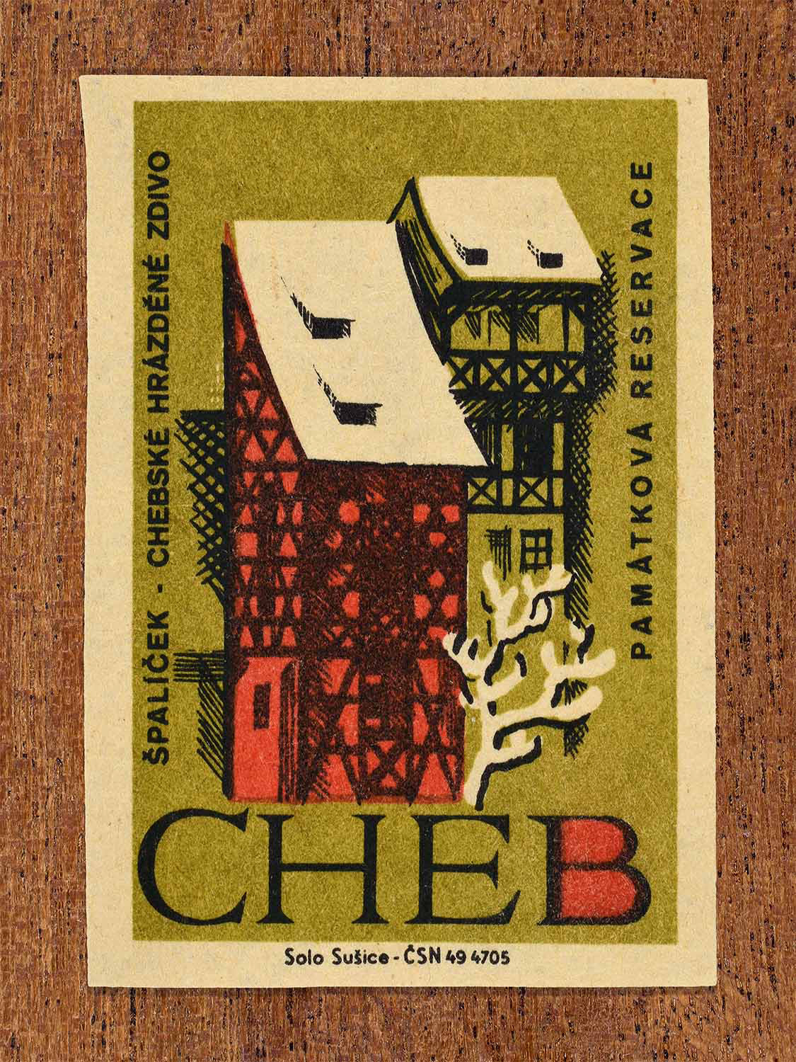 Vintage 1964 Czech matchbox label showing traditional half-timbered houses of Špalíček in Cheb, in olive and red colours. Produced by the Solo Sušice match factory to promote awareness of protected historic monuments.