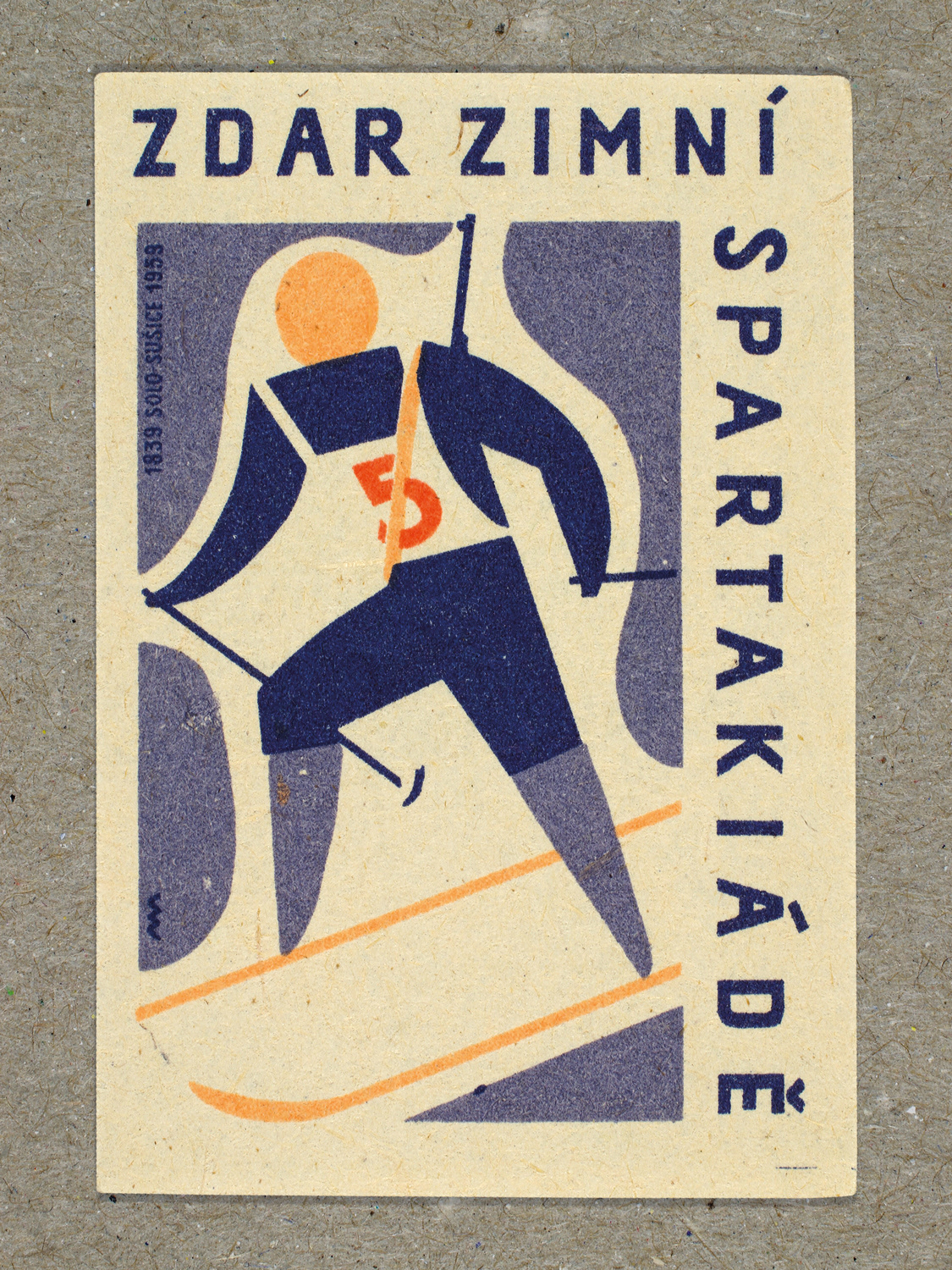 Vintage 1959 Czech matchbox label featuring a stylised figure on skis carrying a rifle on their back, in blue and red colours. Produced by Solo Lipník & Solo Sušice match factory to promote the nationwide Spartakiad sports programme in Czechoslovakia.