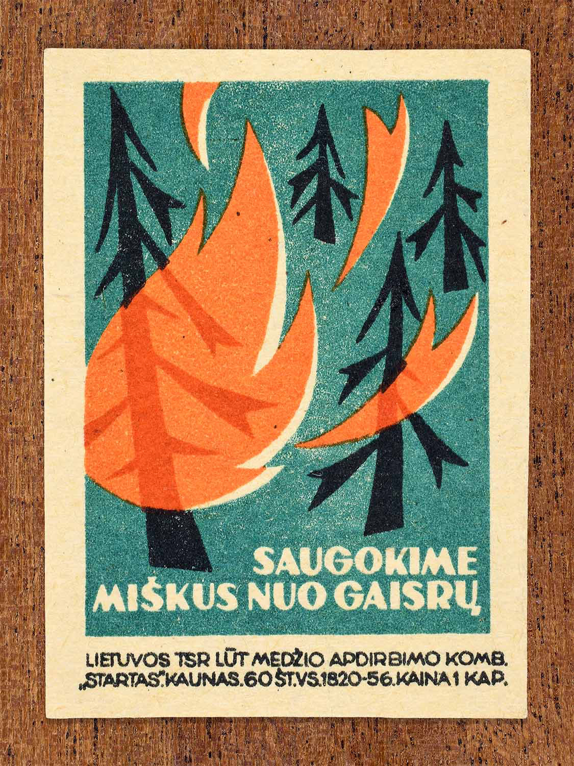 Vintage 1964 Lithuanian matchbox label showing stylised trees engulfed in flames. In black, green and orange colours. Produced by the Startas match factory to promote environmental protection.