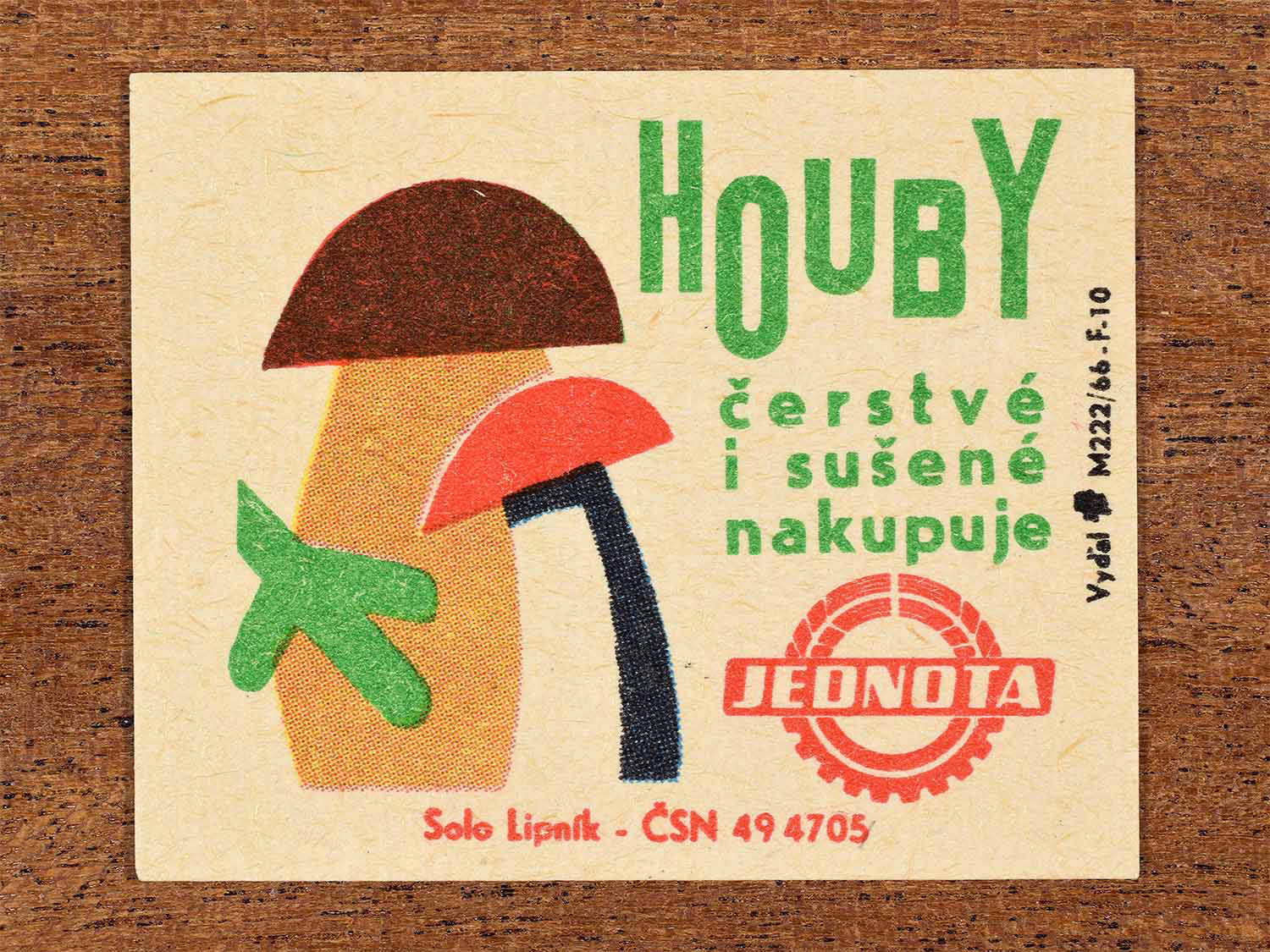 Vintage c. 1966 Czech matchbox label showing stylised mushrooms in brown, red and green shapes. Produced by the Solo Lipník match factory to promote Jednota purchasing fresh and dried mushrooms.