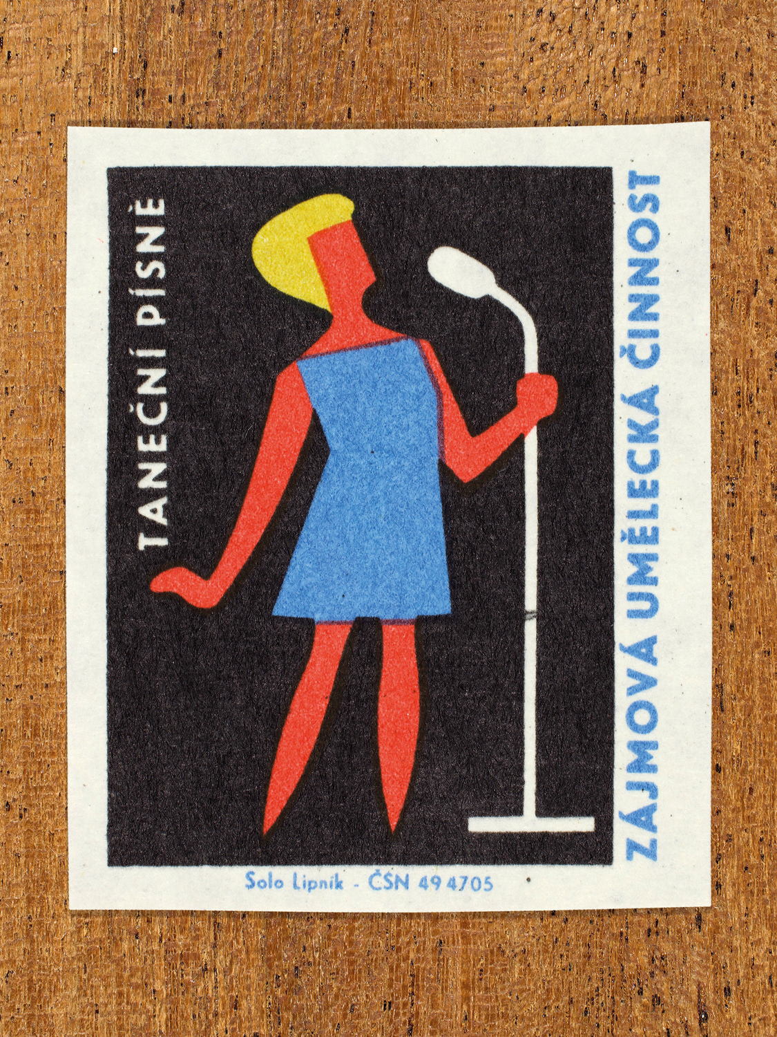 Vintage 1969 Czech matchbox label showing a stylised singer standing at a microphone, in blue, yellow, red and black colours. Produced by the Solo Lipník match factory to promote state-organised art groups in Czechoslovakia.