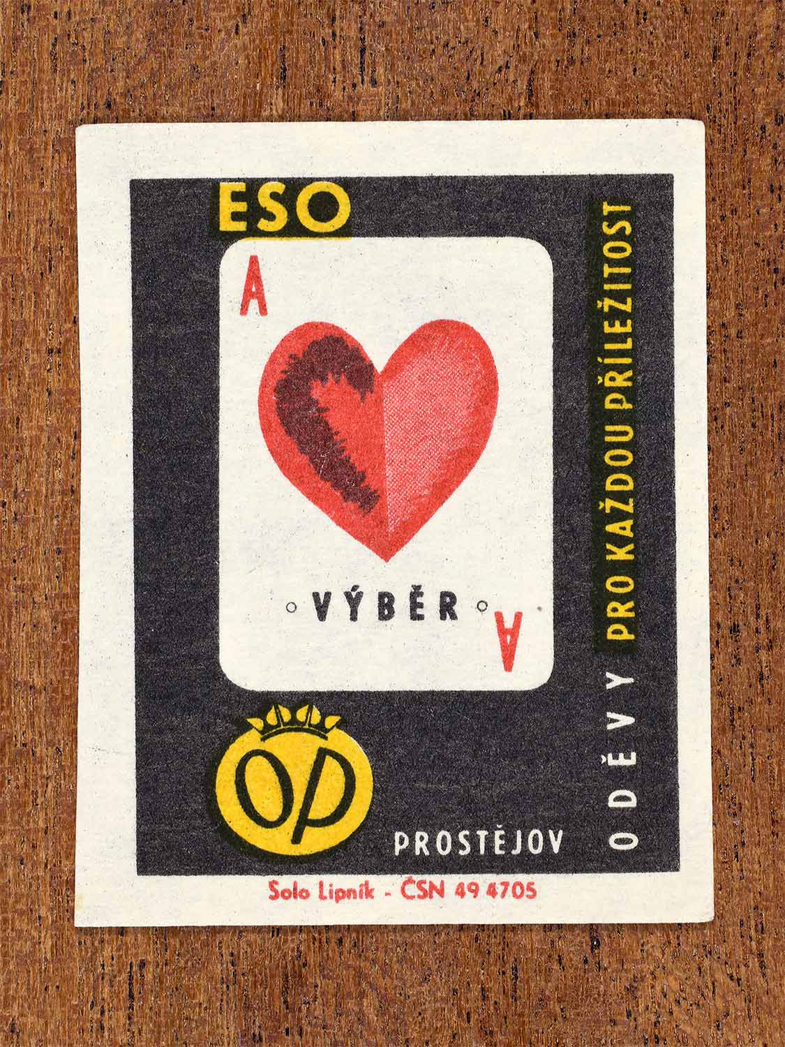 Vintage 1966 Czech matchbox label showing an ace of hearts playing card in red and black. Produced by the Solo Lipník match factory to promote OP Prostějov clothing as a refined consumer choice.
