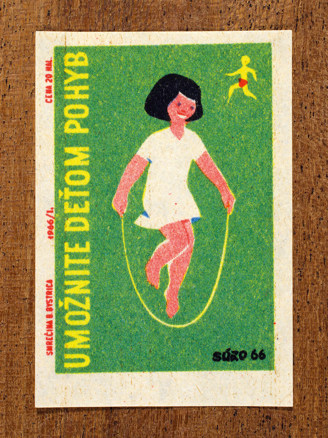 Vintage 1966 Czech matchbox label by Solo Smrečina B. Bystrica featuring a smiling girl with a skipping rope on a green background. It advises that children should stay healthy through outdoor play and physical activity.