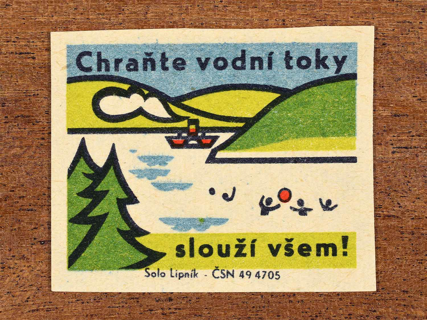 Vintage 1966 Czech matchbox label showing a river landscape with trees and flowing water in green, blue and red colours. Produced by the Solo Lipník match factory to promote protection of waterways for public benefit.