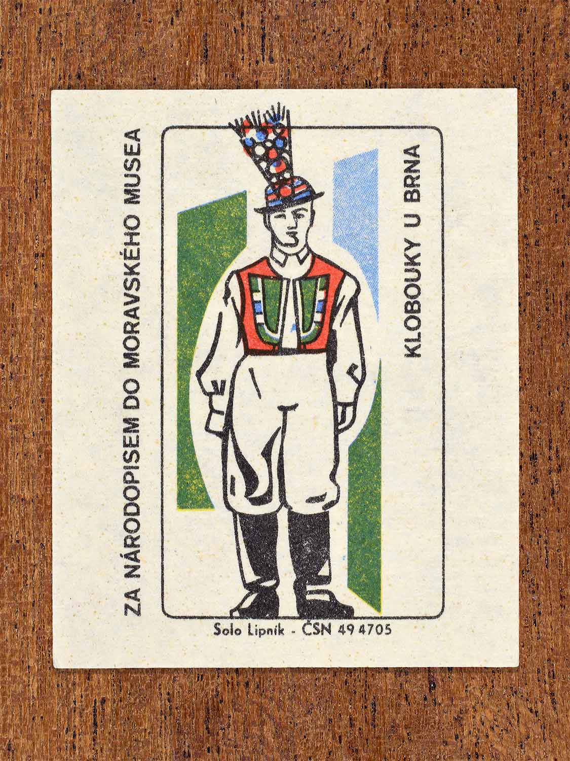 Vintage 1968 Czech matchbox label showing a male folk costume from Klobouky near Brno with embroidered vest and ceremonial hat. Produced by the Solo Lipník match factory to promote Moravian ethnography via the Moravian Museum.