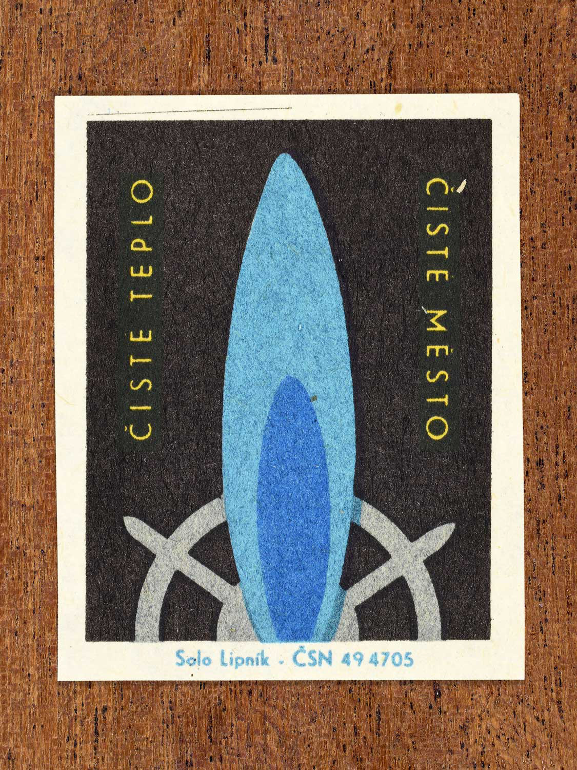 Vintage c. 1966 Czech matchbox label showing a large blue gas flame on a black background. Produced by the Solo Lipník match factory to promote safe, modern, and responsible domestic propane–butane gas use.
