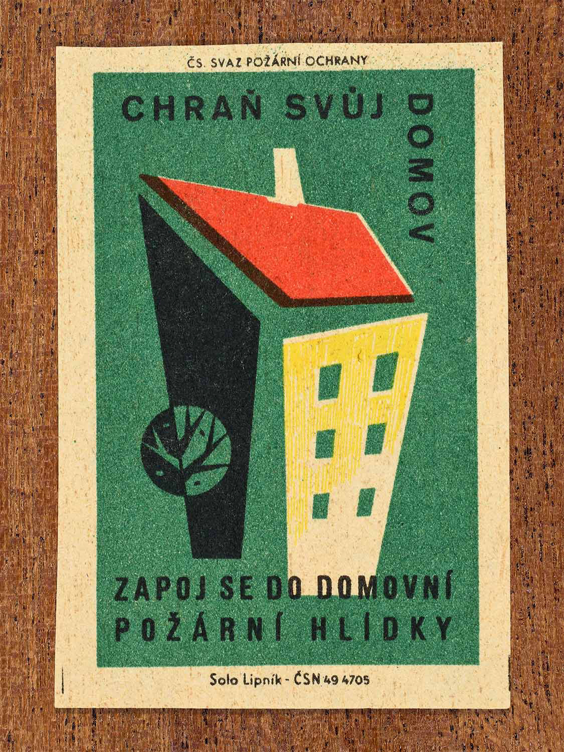 Vintage c. 1961 showing a geometric house in green, yellow, and black colours. Produced by the Solo Lipník match factory to encourage joining a domestic fire patrol to help protect the home.