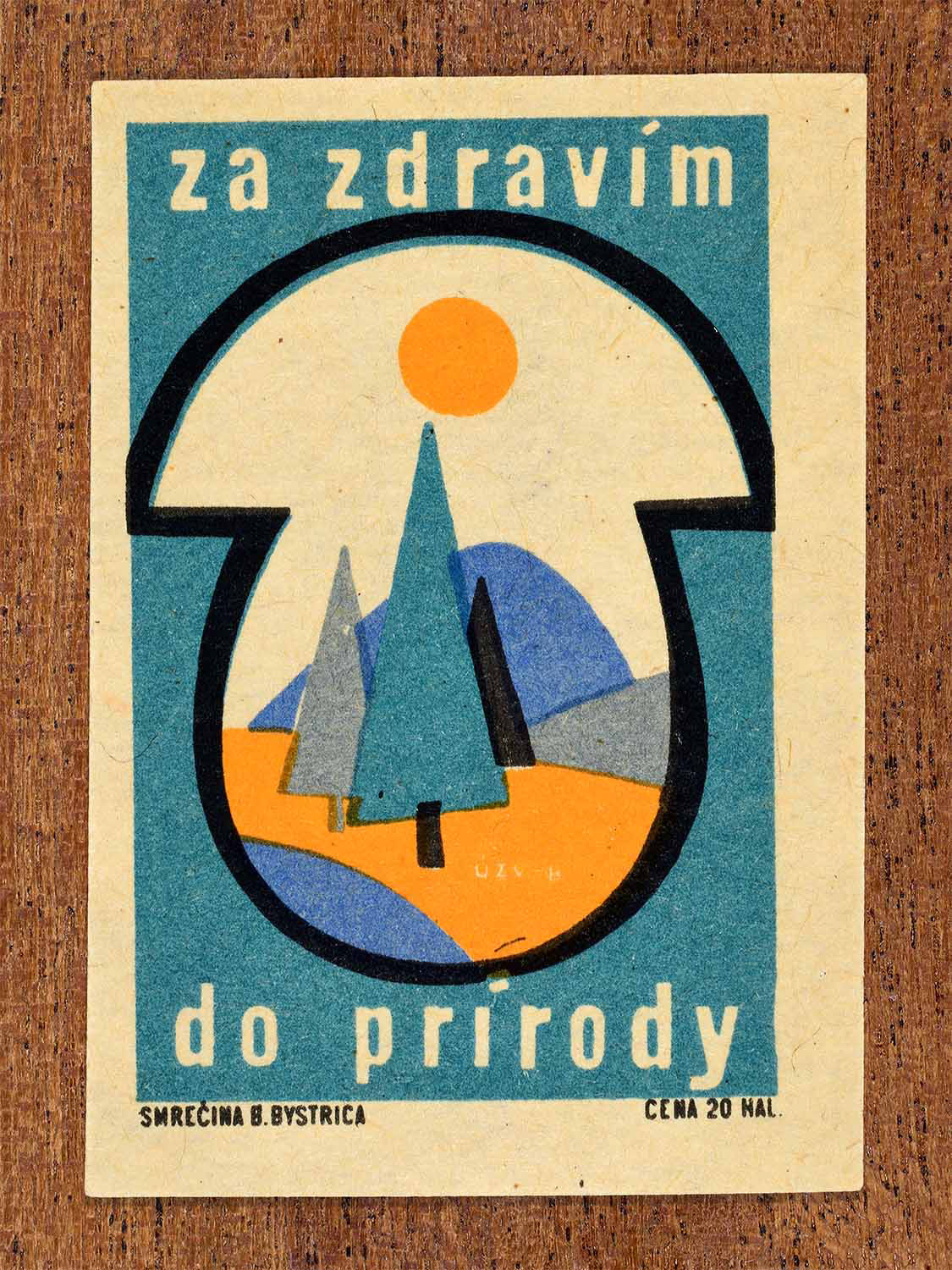 Vintage 1967 Czech matchbox label showing trees, mountains and sun in blue and orange colours. Produced by the Smrečná match factory, Banská Bystrica, to promote outdoor activity in nature for better health.