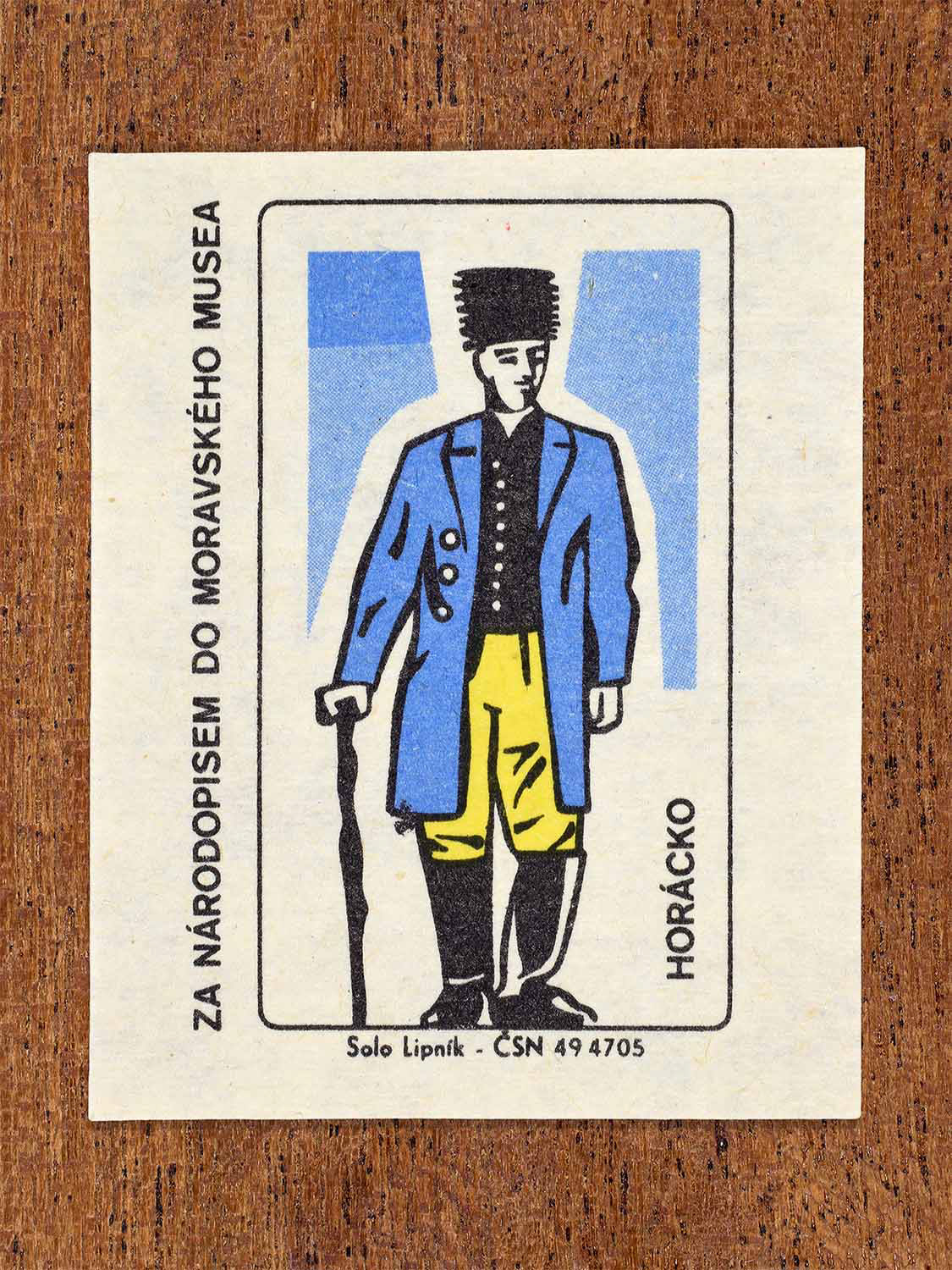 Vintage 1968 Czech matchbox label showing a male folk costume from the Horácko region with long coat and traditional hat. Produced by the Solo Lipník match factory to promote Moravian ethnography via the Moravian Museum.