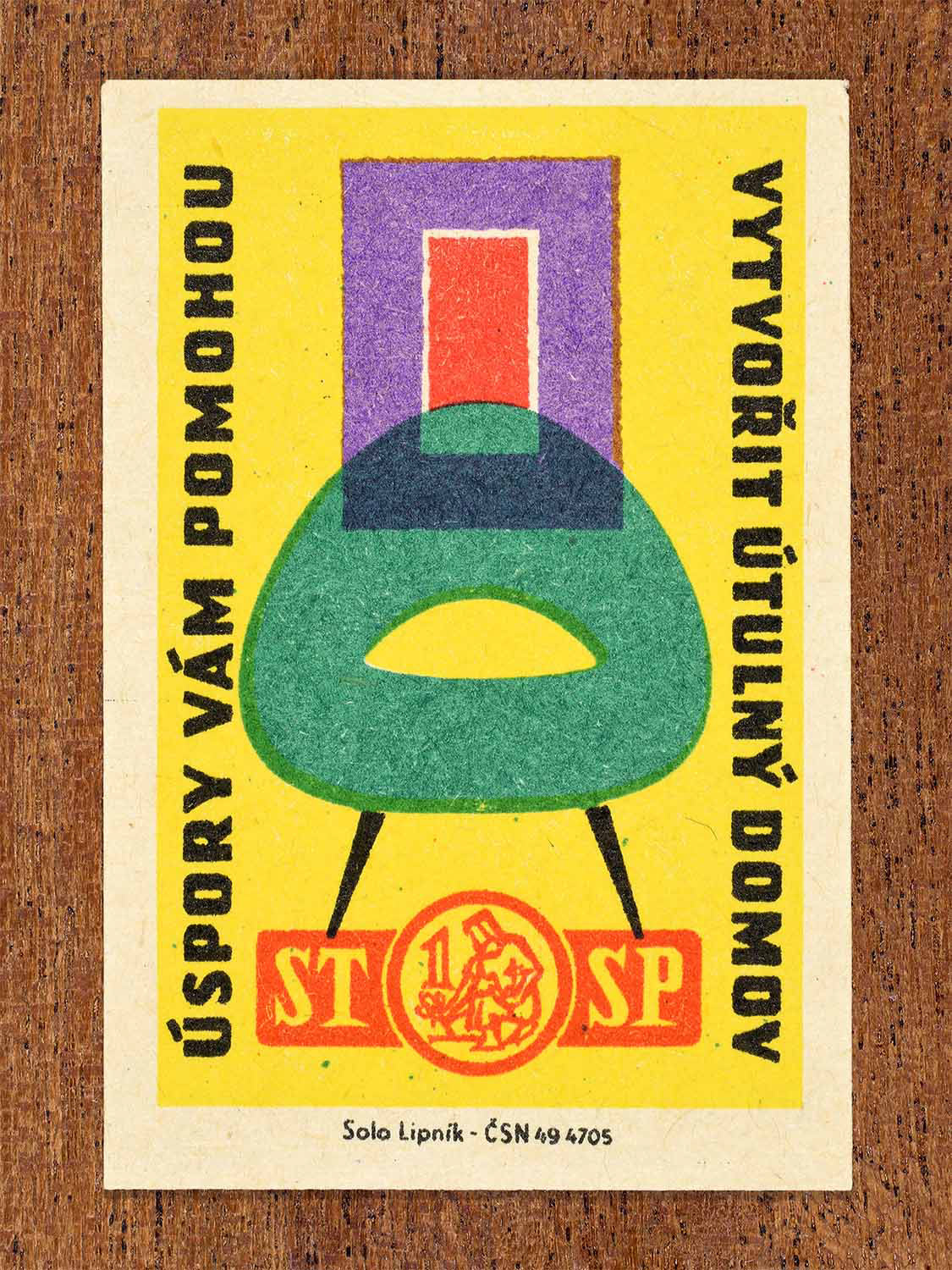 Vintage 1960 Czech matchbox label showing a stylised chair and window in bright colours. Produced by the Solo Lipník match factory to promote saving money to create a comfortable home.