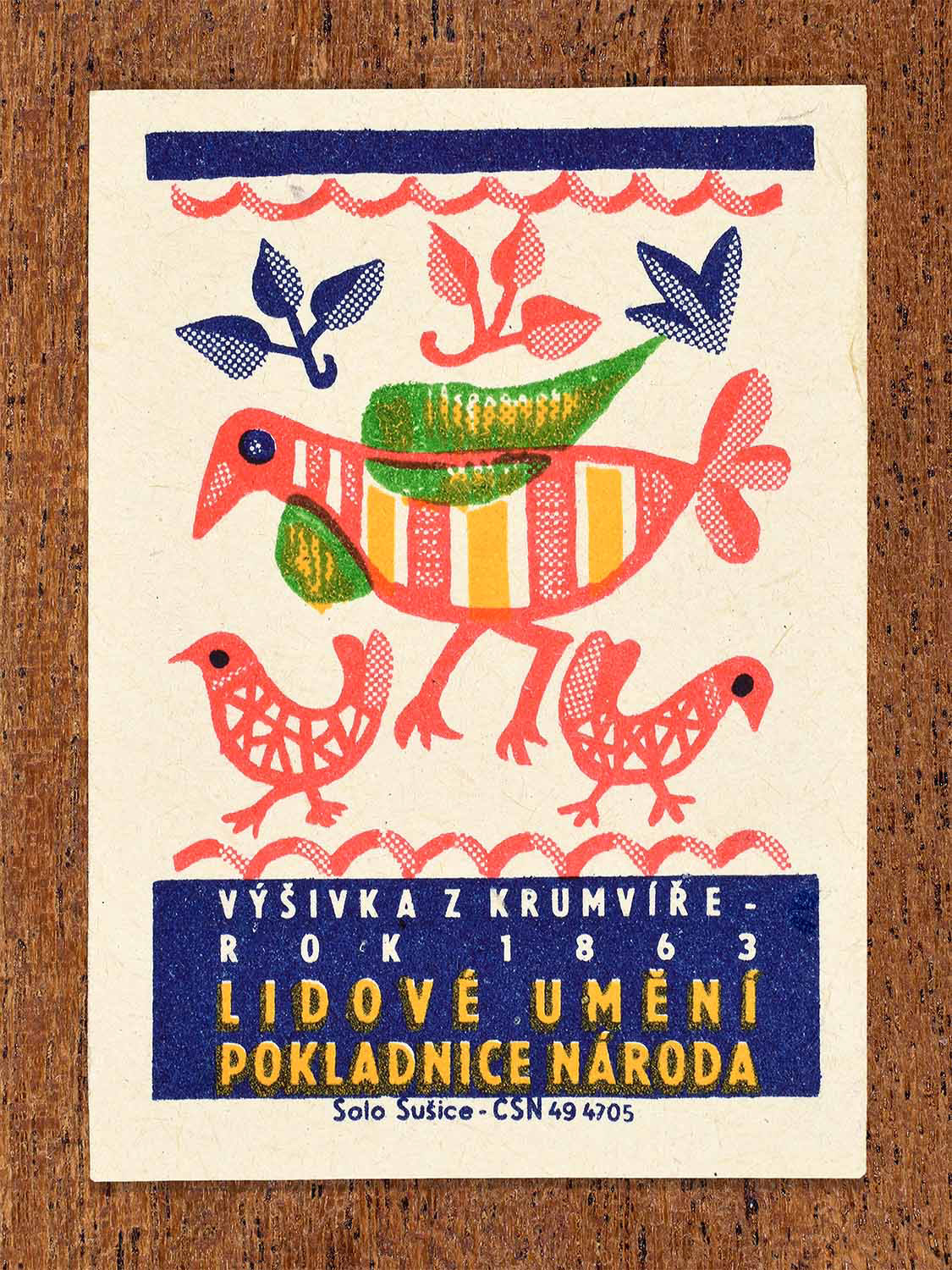 Vintage 1964 Czech matchbox label showing stylised folk birds and floral motifs in red, blue, green and yellow. Produced by the Solo Sušice match factory to celebrate traditional Moravian embroidery from Krumvíř.