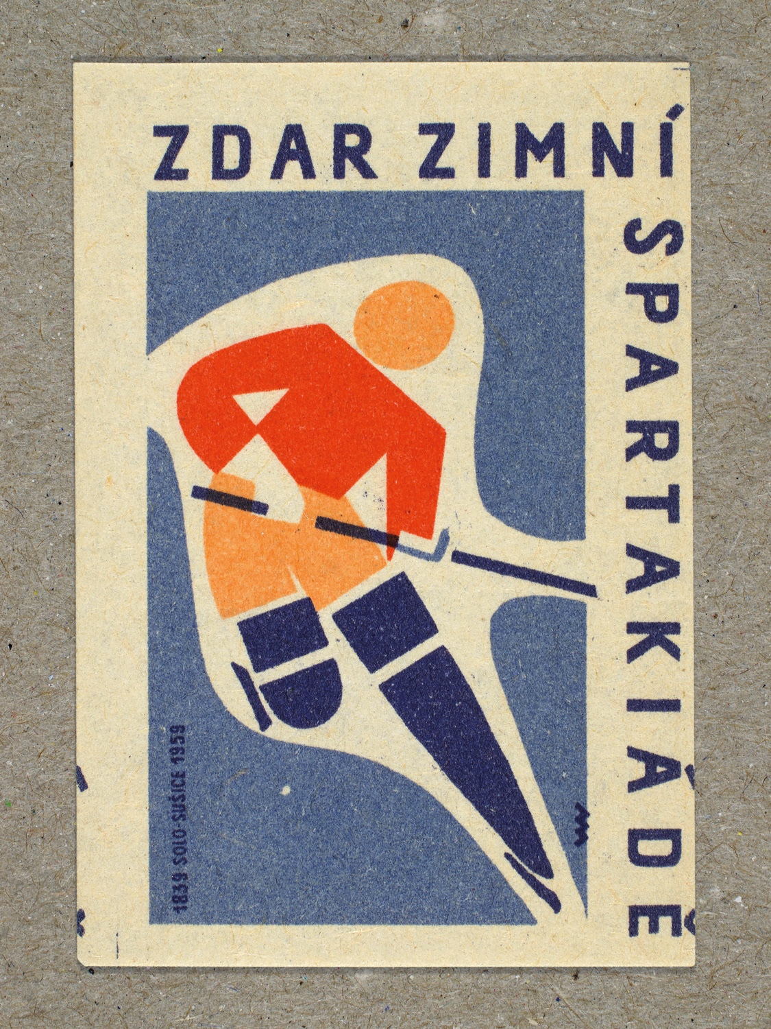 Vintage 1959 Czech matchbox label featuring a stylised figure on skates holding a hockey stick, in blue and red colours. Produced by Solo Lipník & Solo Sušice match factory to promote the nationwide Spartakiad sports programme in Czechoslovakia.
