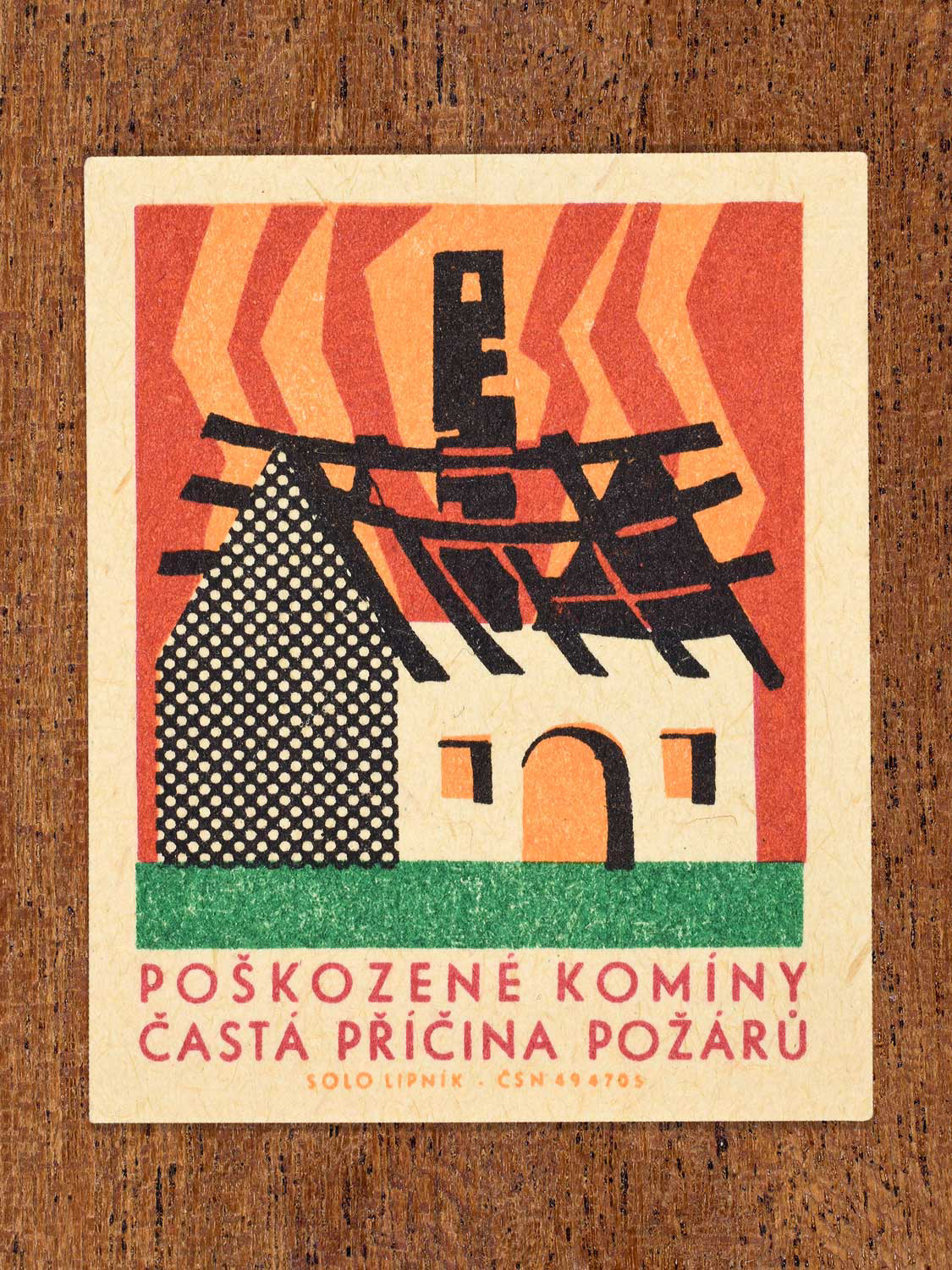 Vintage 1966 Czech matchbox label featuring a stone barn with a burning roof and chimney, and heatwave lines in red and orange behind it. Produced by Solo Lipník match factory to promote the importance of fire safety precautions.